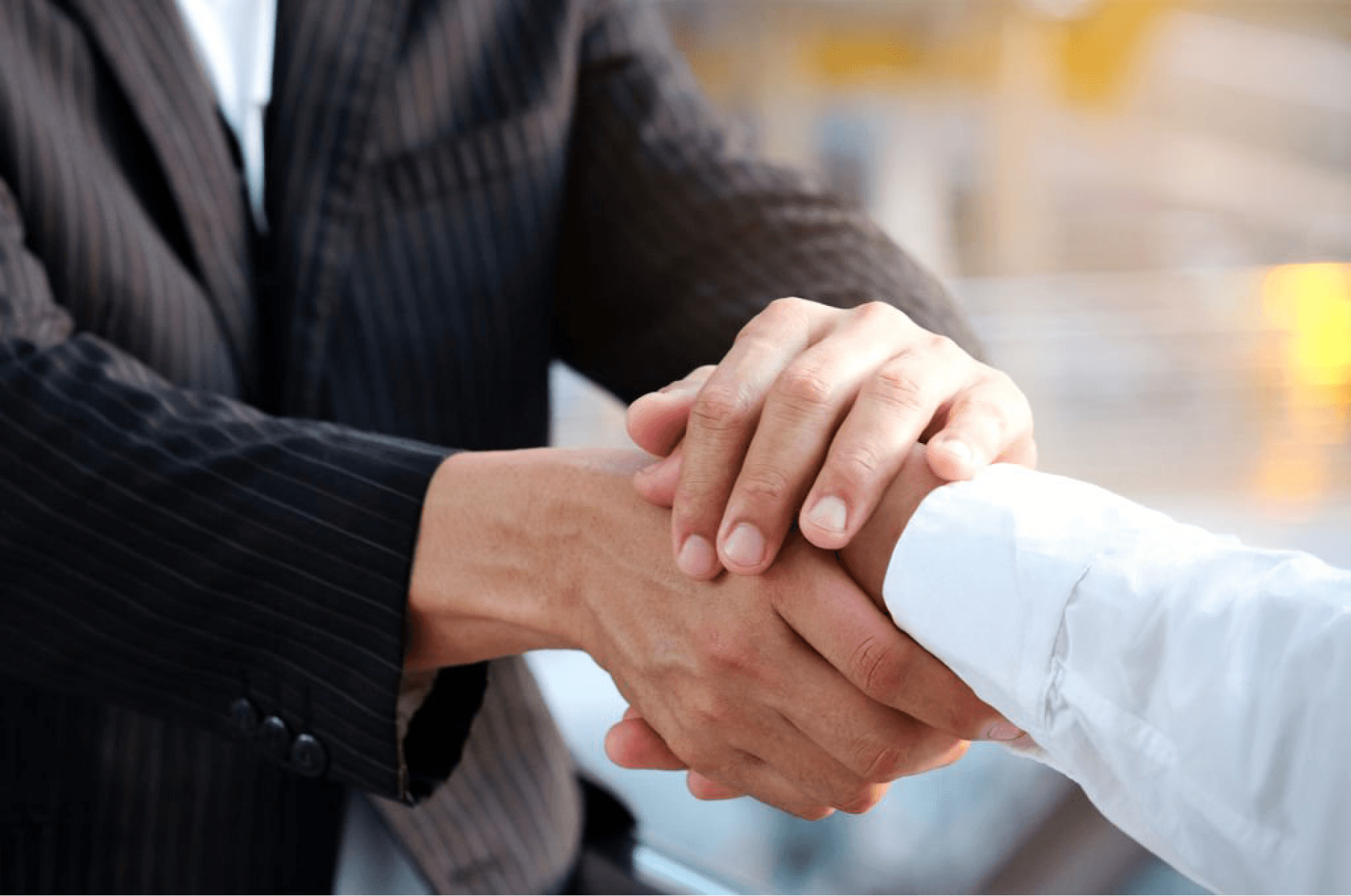 Close-up of a professional handshake, symbolizing partnership or agreement in a business setting.