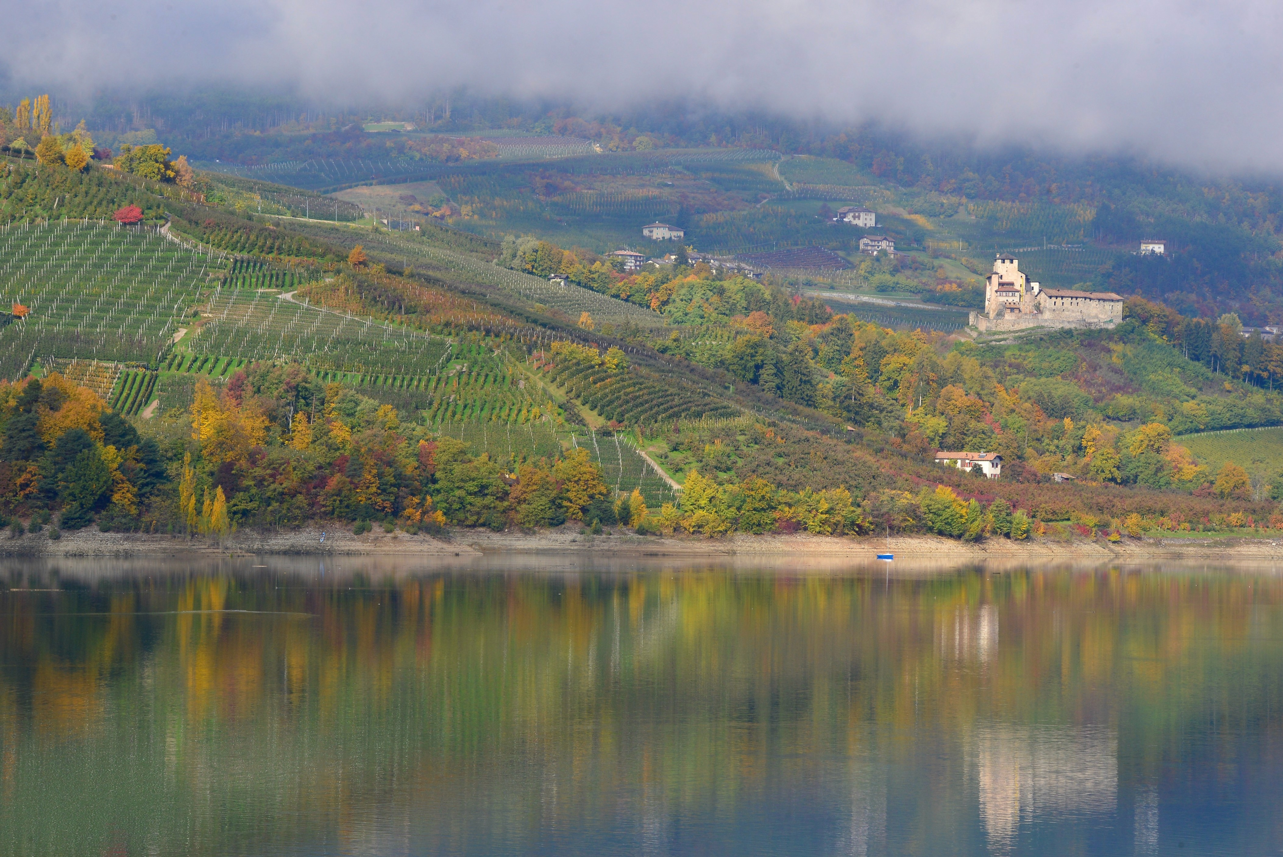 Alpine trout fishing in Lake Santa Giustina, surrounded by the Brenta Dolomites and apple orchards