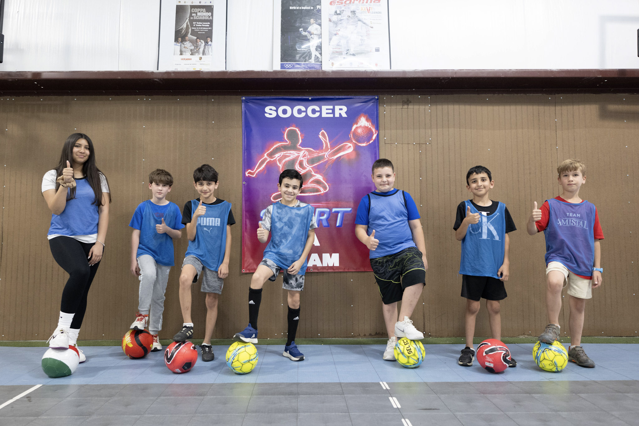 A soccer class posing for a picture at the SportPlus gym