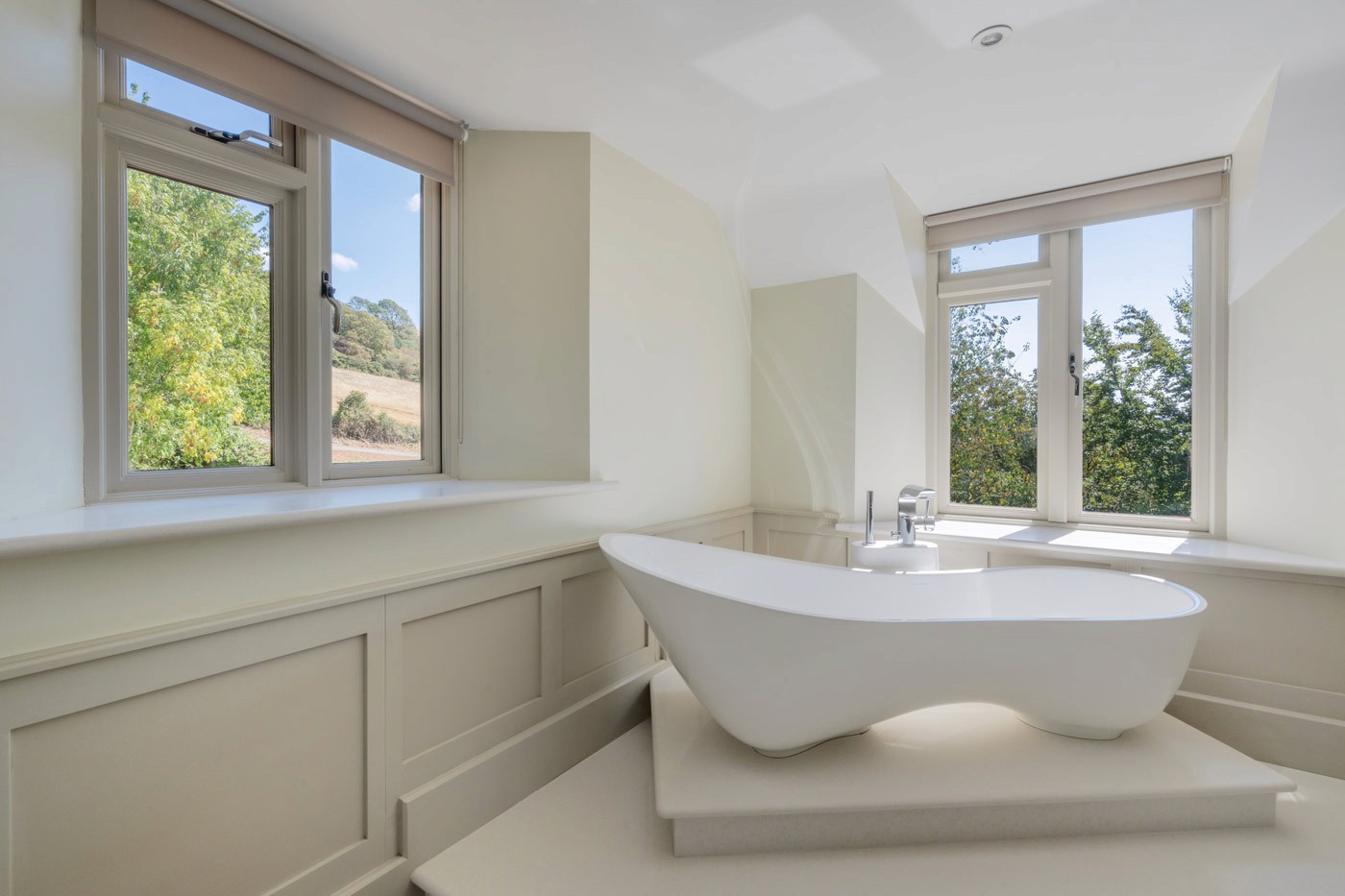 bathroom with freestanding bath and countryside outlook