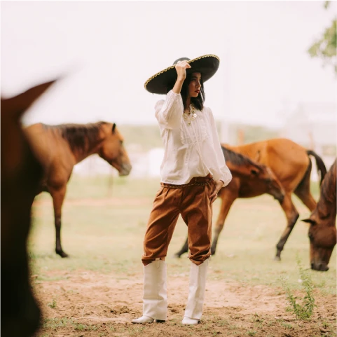 Two people riding horses on a ranch