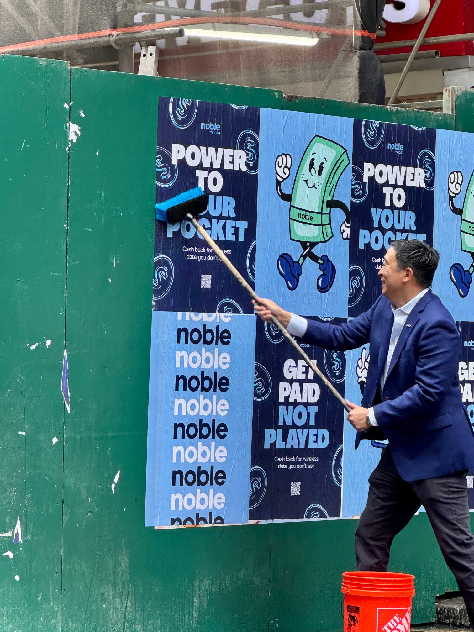 Andrew Yang wheatpasting Noble Mobile posters in New York