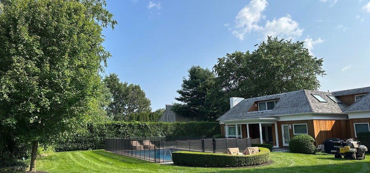 Green lawn beside a backyard pool