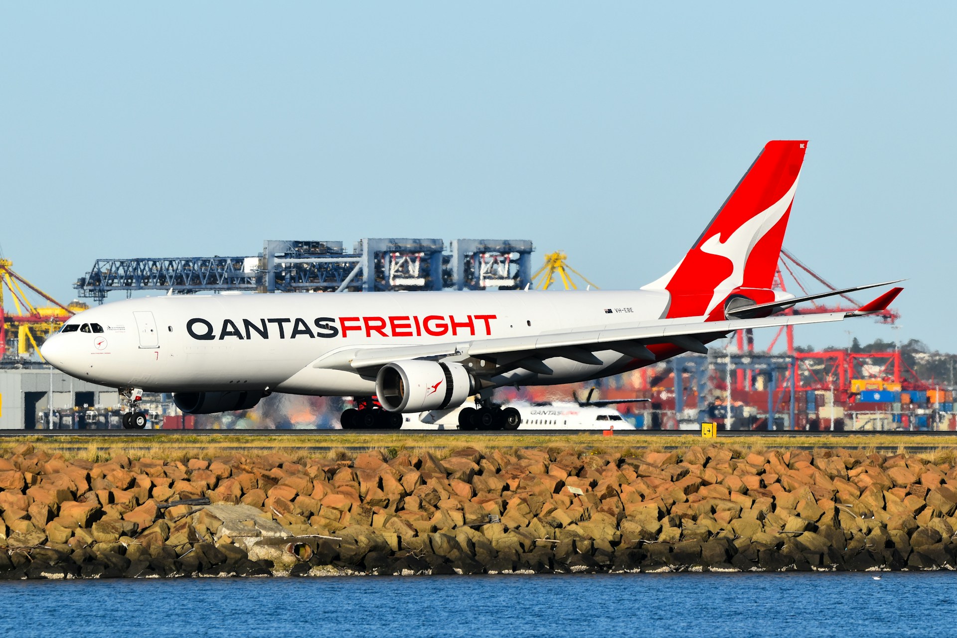 Man with a laptop walking to a store