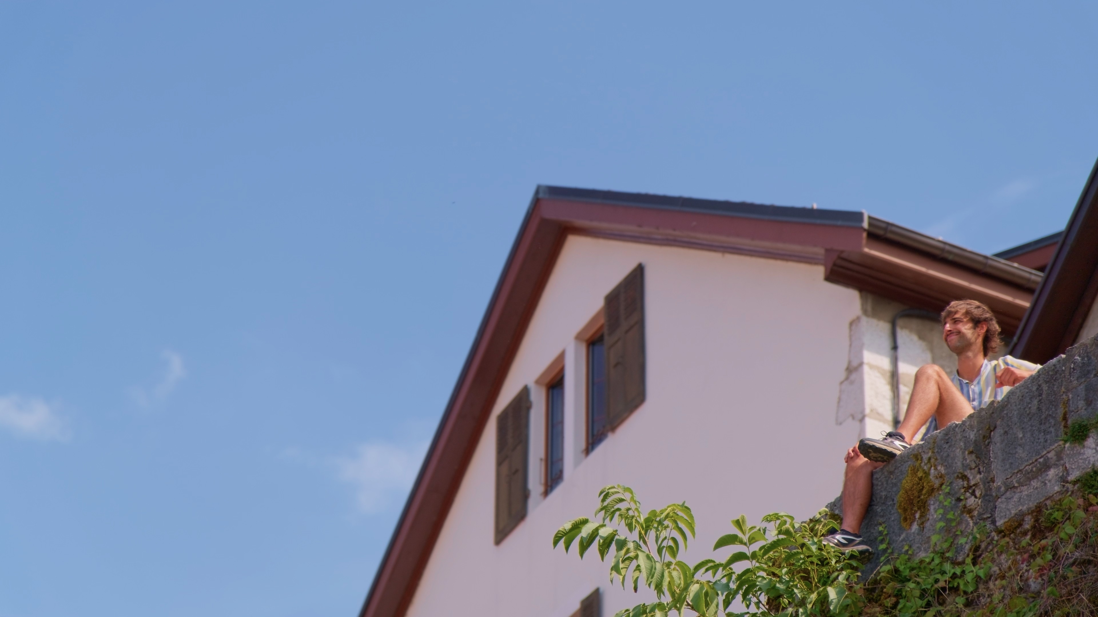 Modern living room with red sofa and grey chairs.