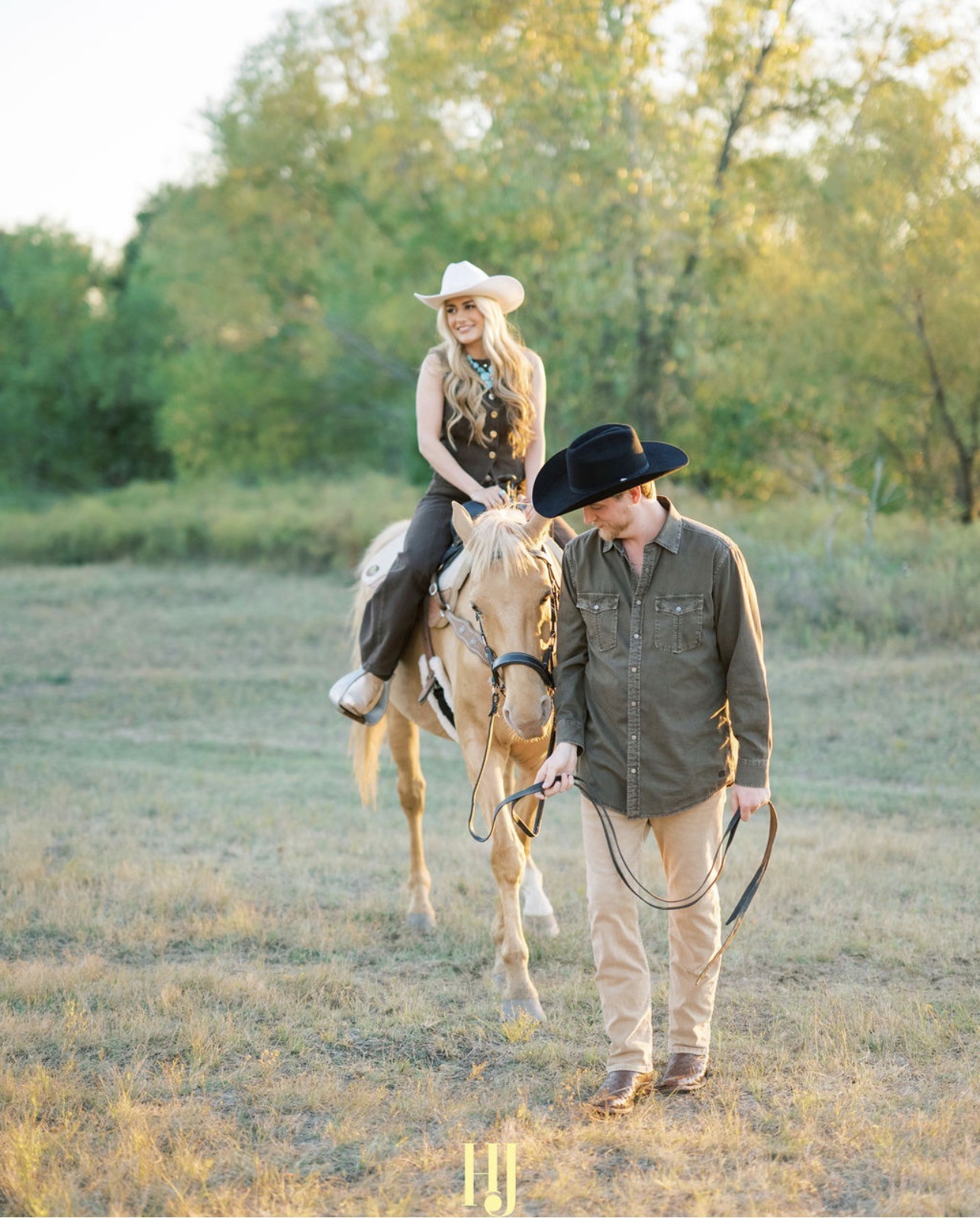 Couple portrait with dog on field