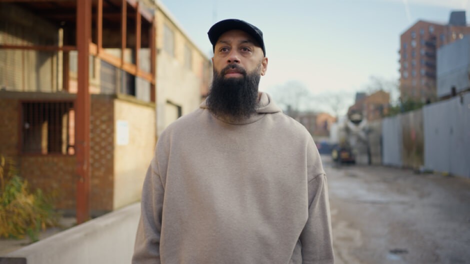 NAZ HUSSAINUK from the UK standing in a sunlit urban street