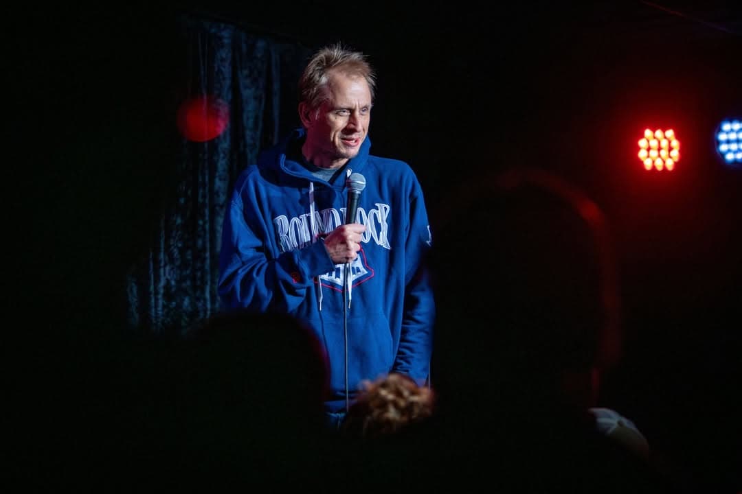 Davey Wester performing Stand Up Comedy with a hoodie on