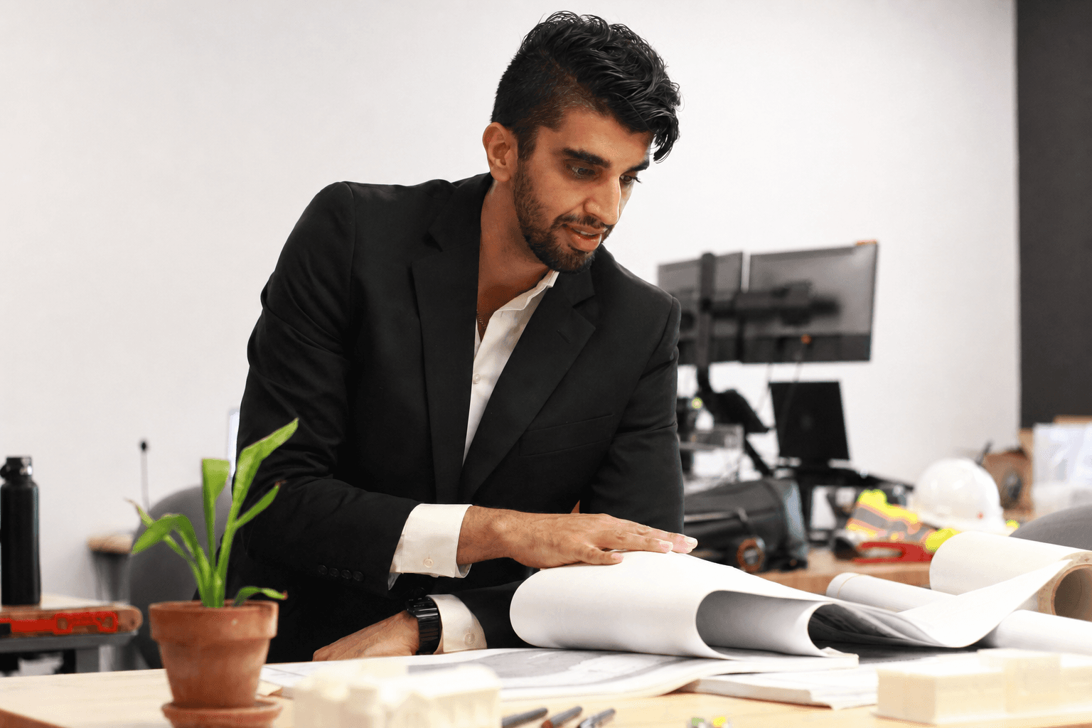 Sanbir Sidhu reviewing architectural drawings