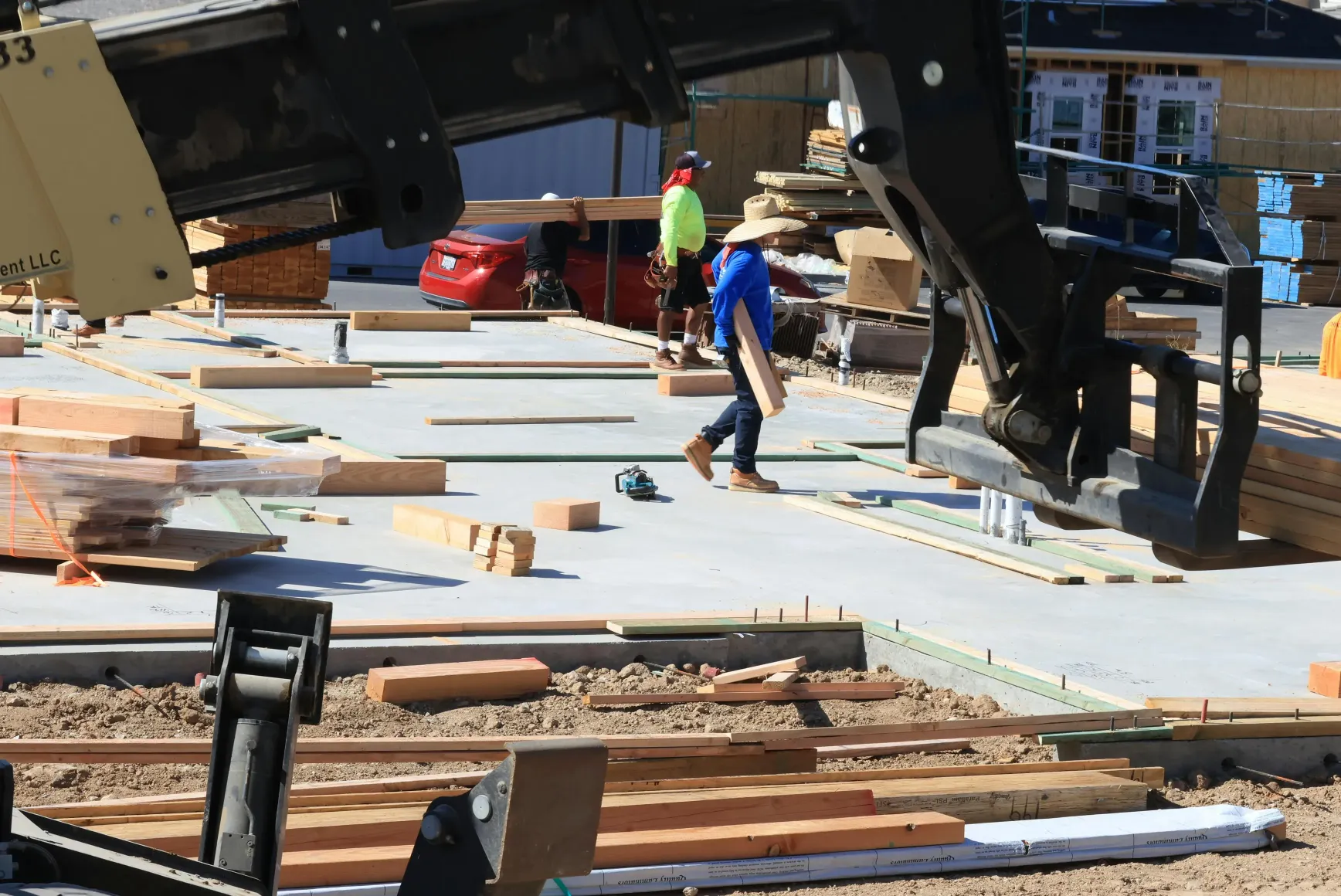 construction-workers-actively-building-a-structure-with-timber-and-machinery-out - david-brown (pexels)
