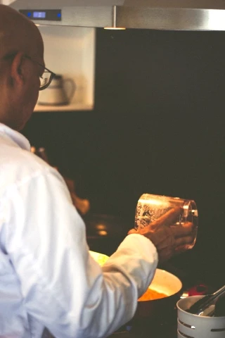 Over the shoulder photo of Chef Roony cooking.