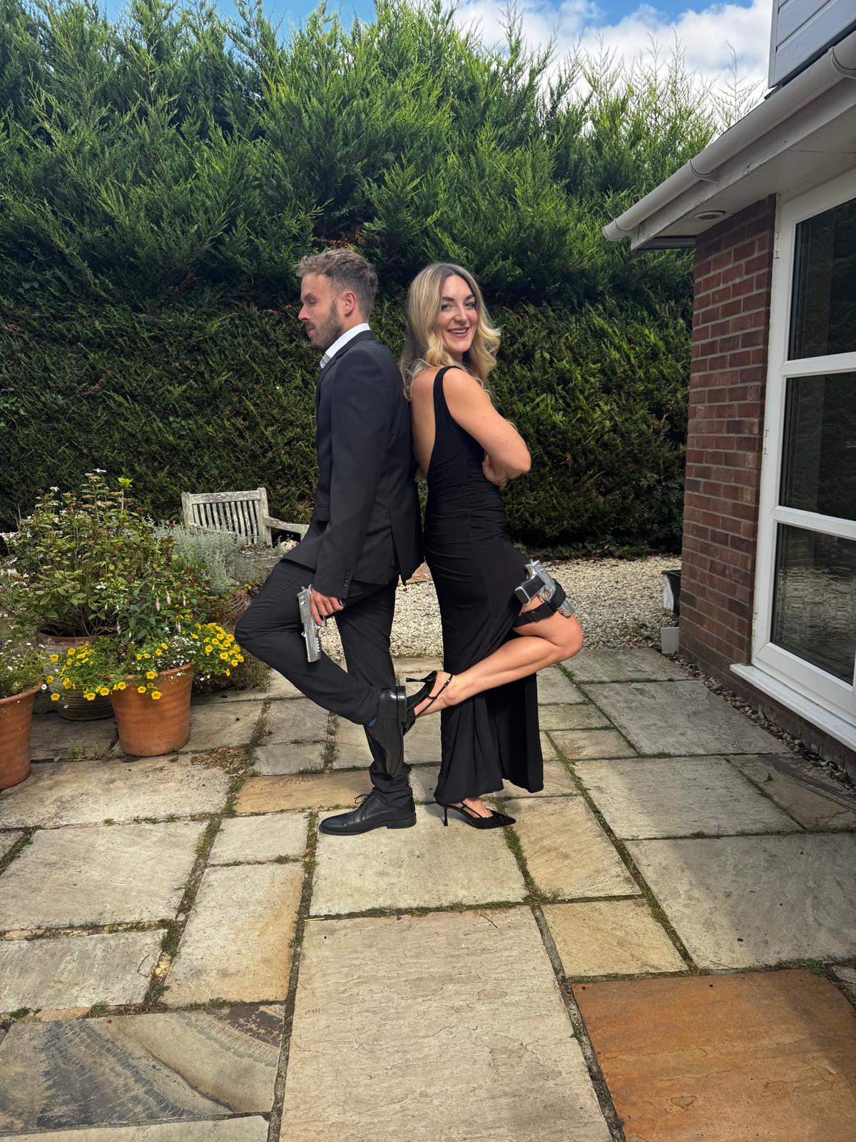 A bride and groom share a kiss, enveloped in the bride's flowing veil. The soft focus and gentle light convey a romantic, intimate atmosphere.