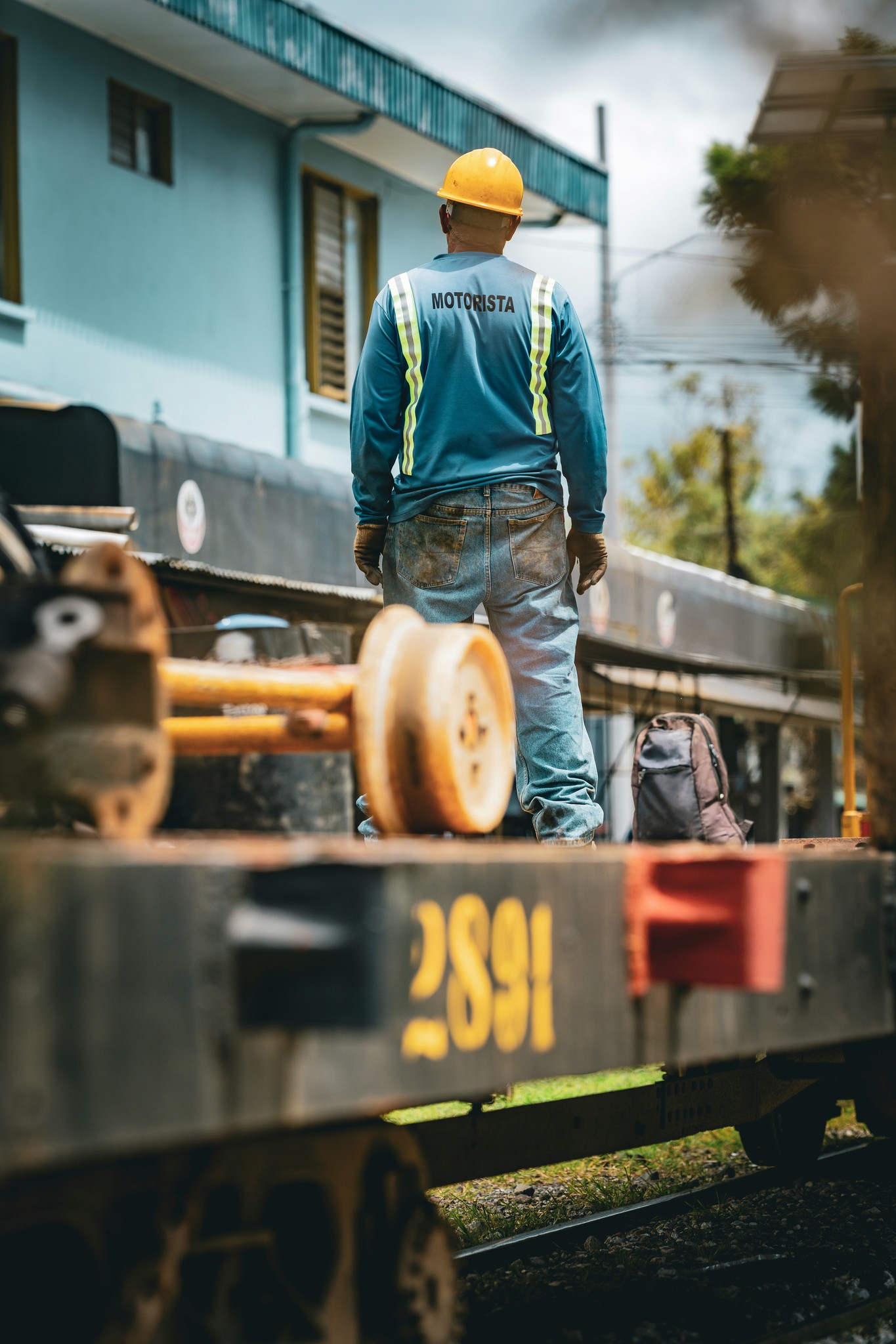 Construction worker standing on train car