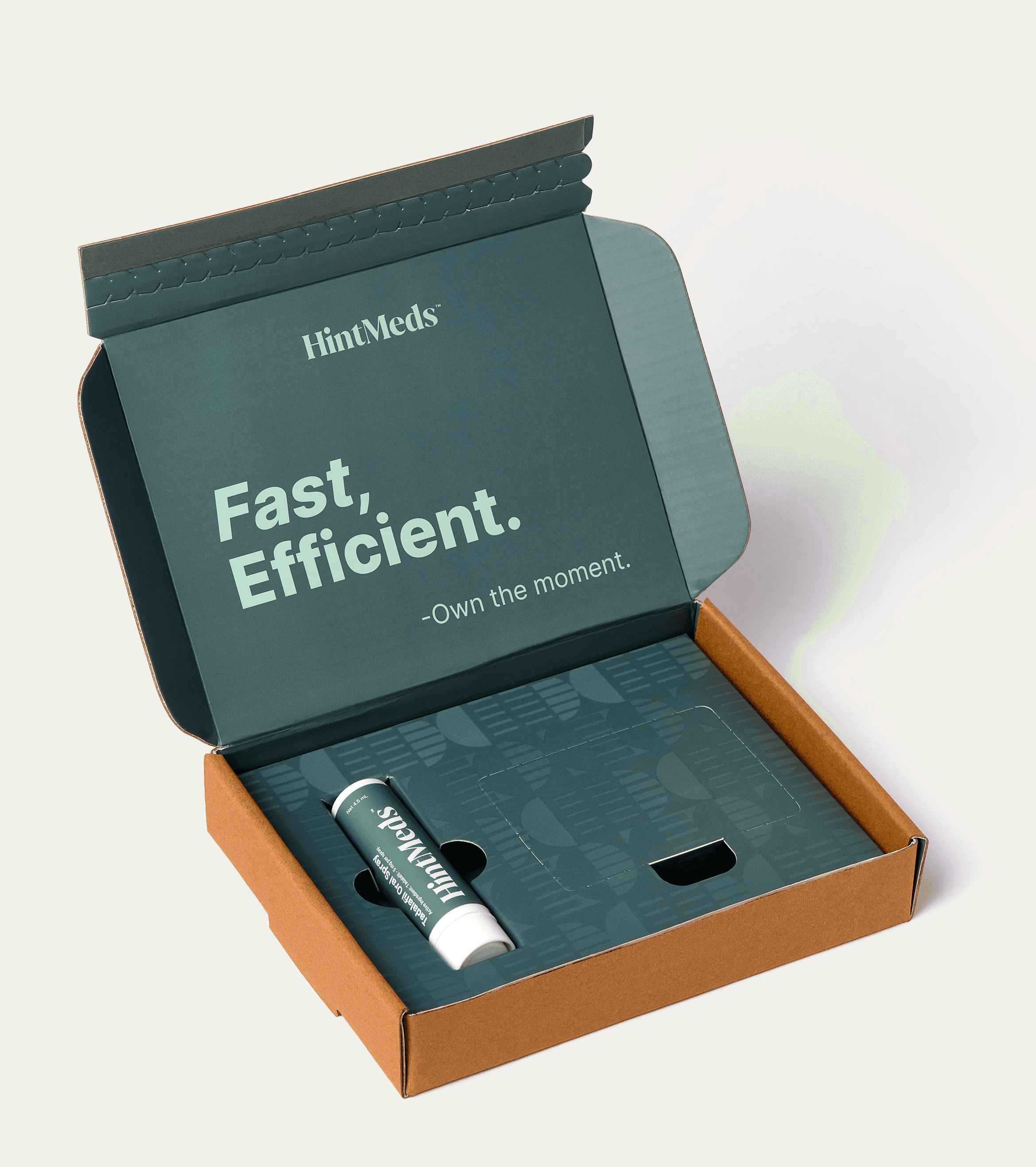 Open box with a teal interior, featuring a label that says "Fast. Efficient." and a small tube inside.