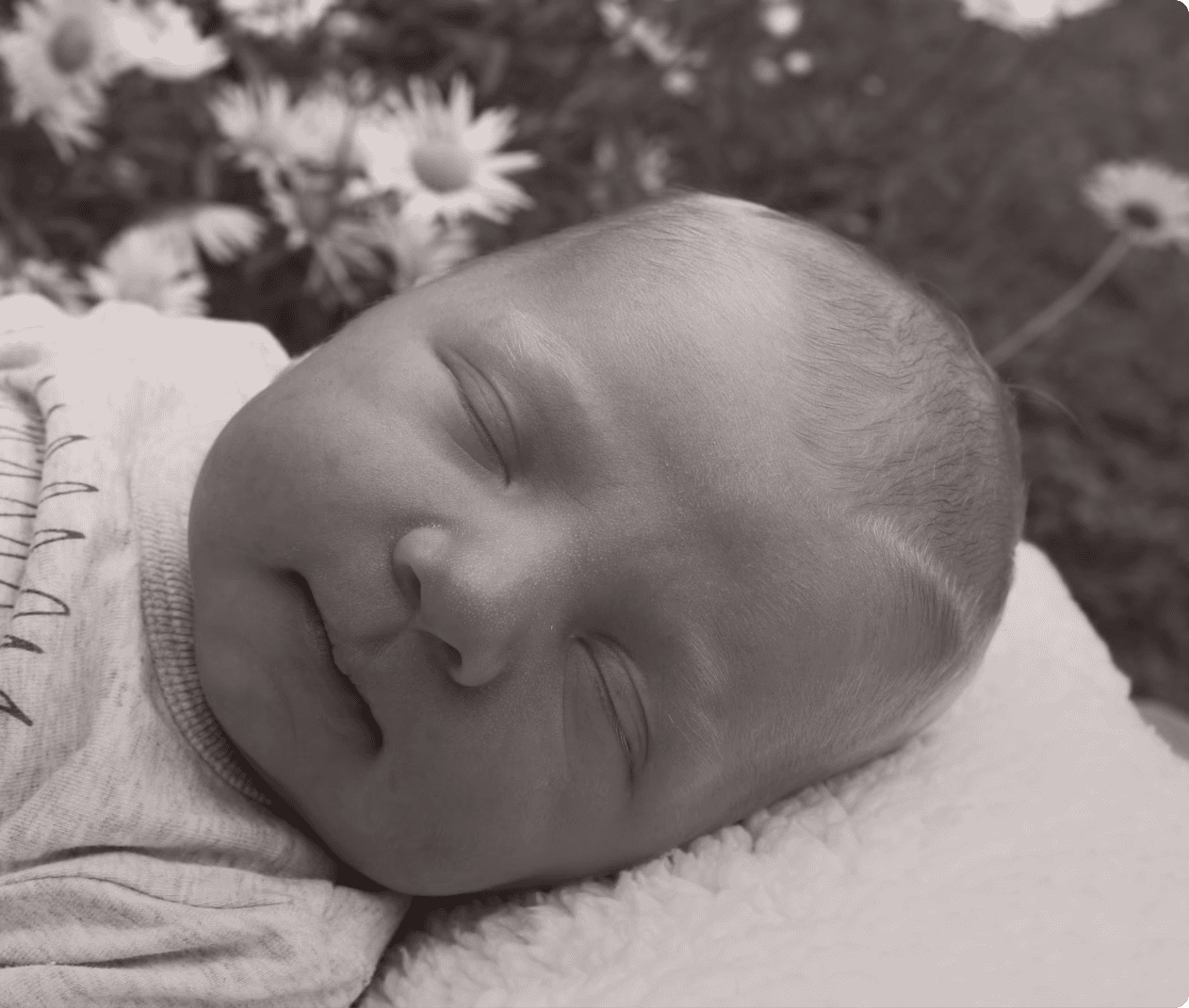 Baby Boy Sleeping in Garden