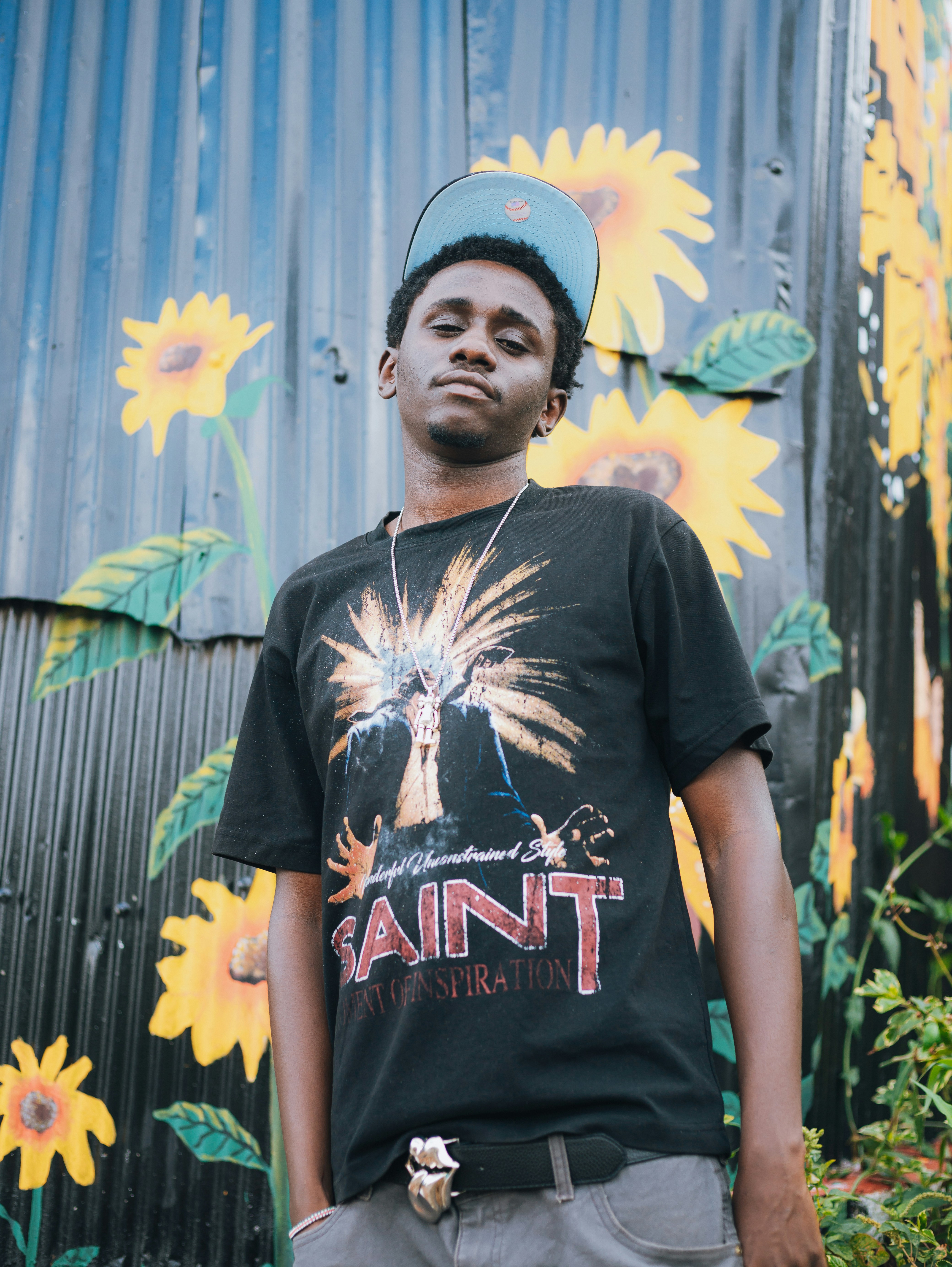 Young man in a t-shirt with sunflowers on the background