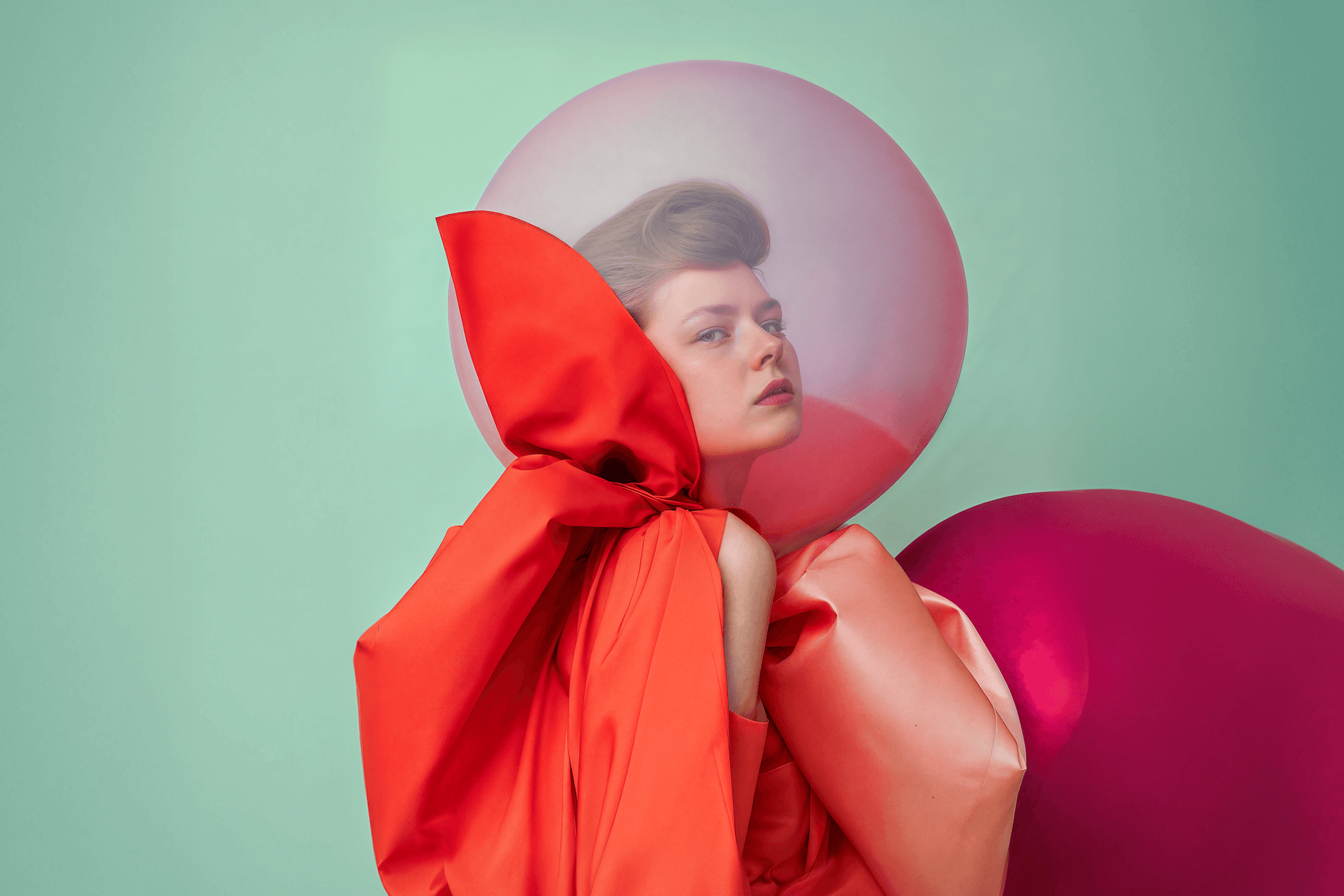 Artistic fashion portrait with colorful geometric shapes and avant-garde red styling