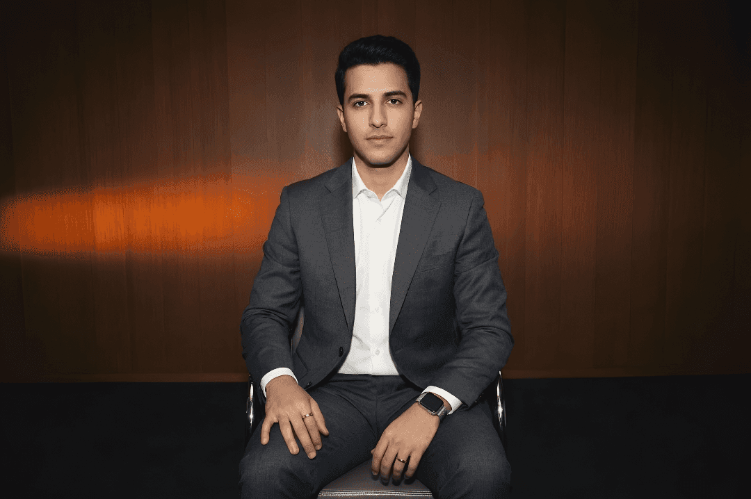 A close-up portrait of a smiling man