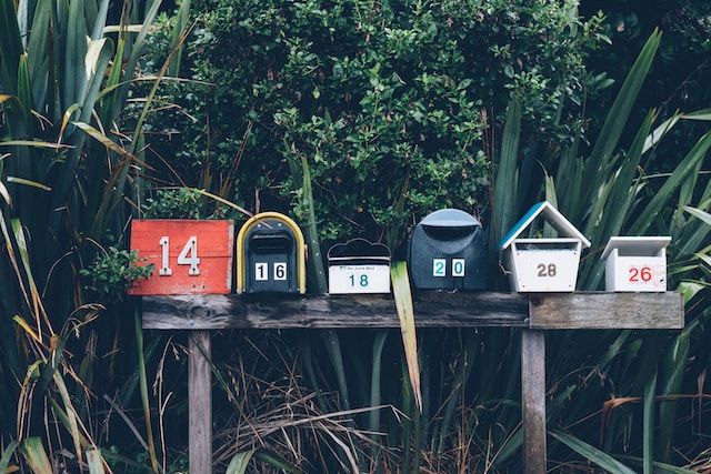 A shelf with multiple mailboxes.