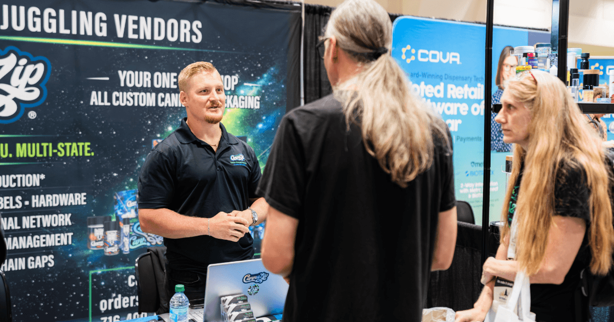 Davis Tiburzi speaks with attendees at the CannaZip booth during CannaCon Midwest 2026.