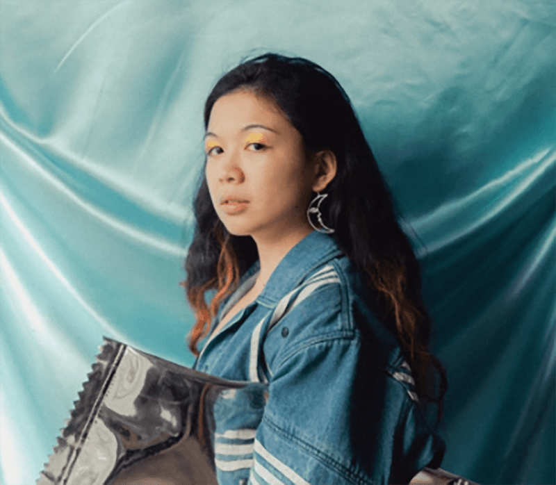 portrait of a woman with long hair looking at the camera. fabric background