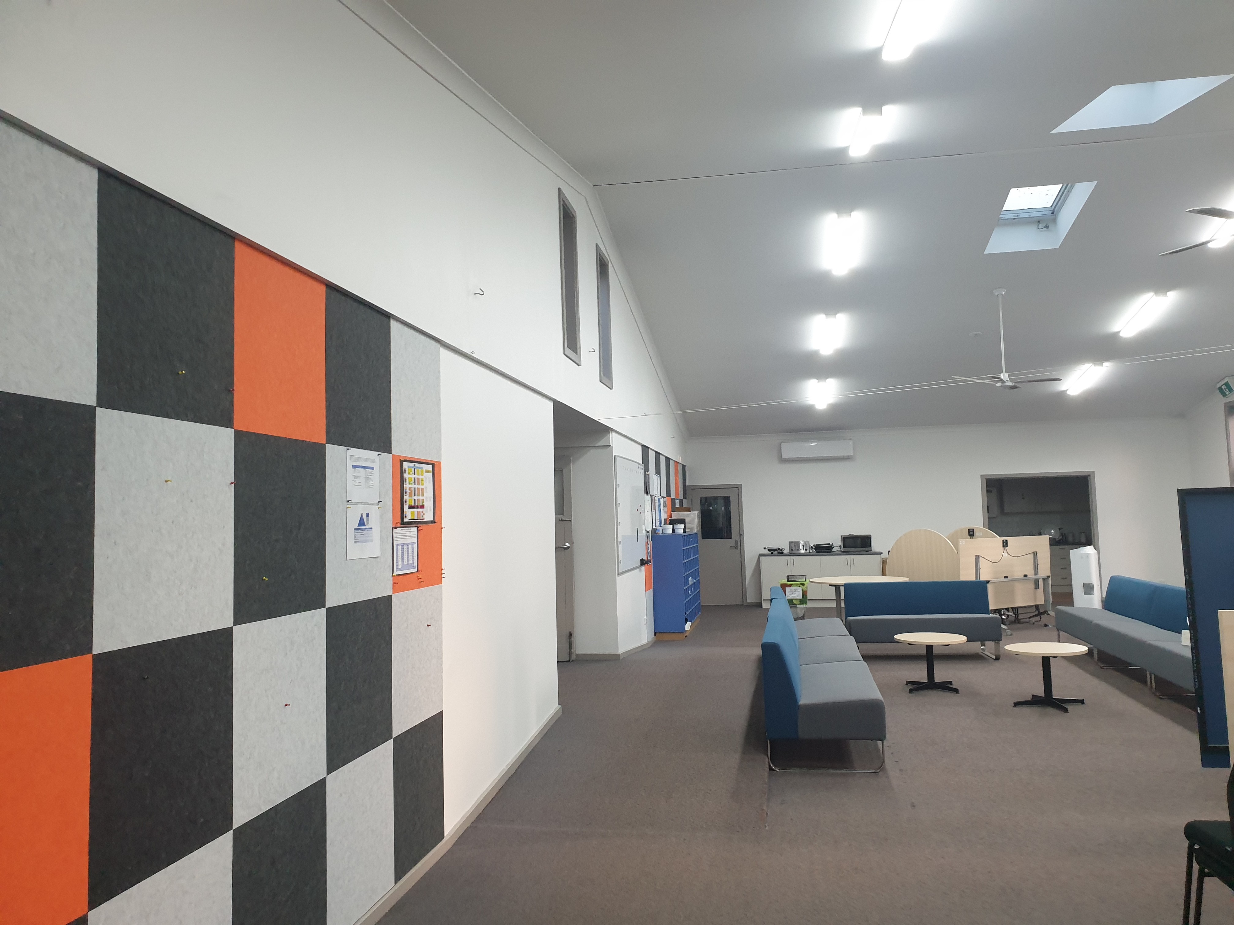 Freshly painted commercial space with modern, colorful wall panels by Alicon Painting.