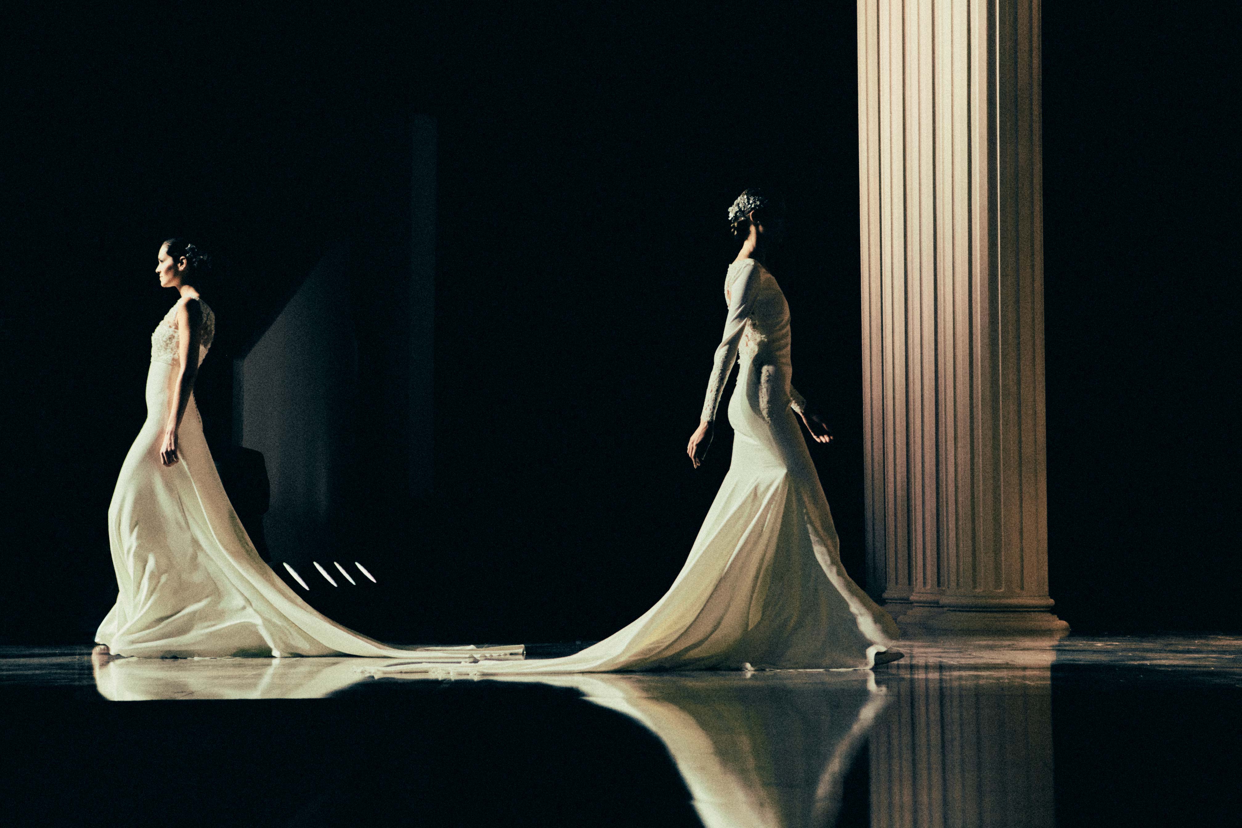 A fast black sports car races down the highway.