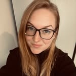 smiling woman wearing white and black pinstriped collared top