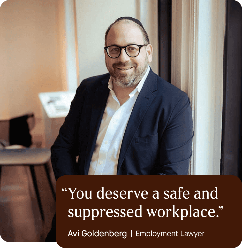 Image of Avi Goldenberg, Employment Lawyer, in his office wearing a button down shirt and suit jacket, wearing glasses and smiling. Quote overlaid.