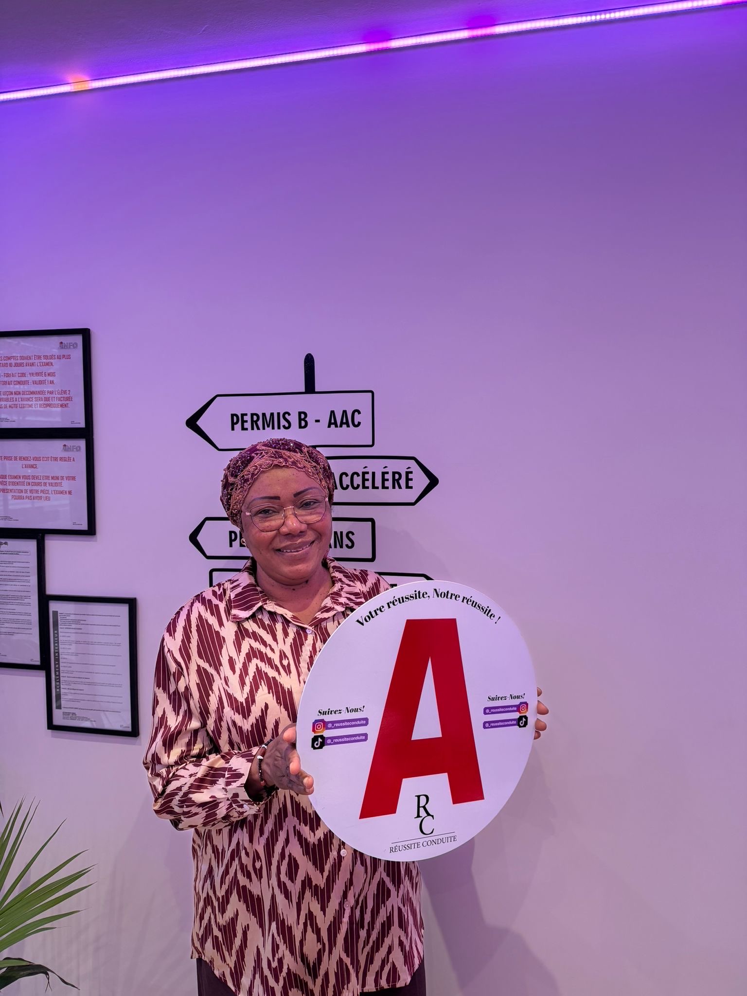 man in black jacket holding blue tablet computer