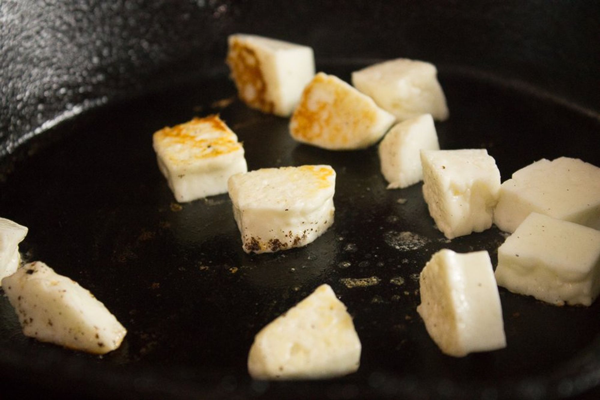 cubed halloumi in a pan