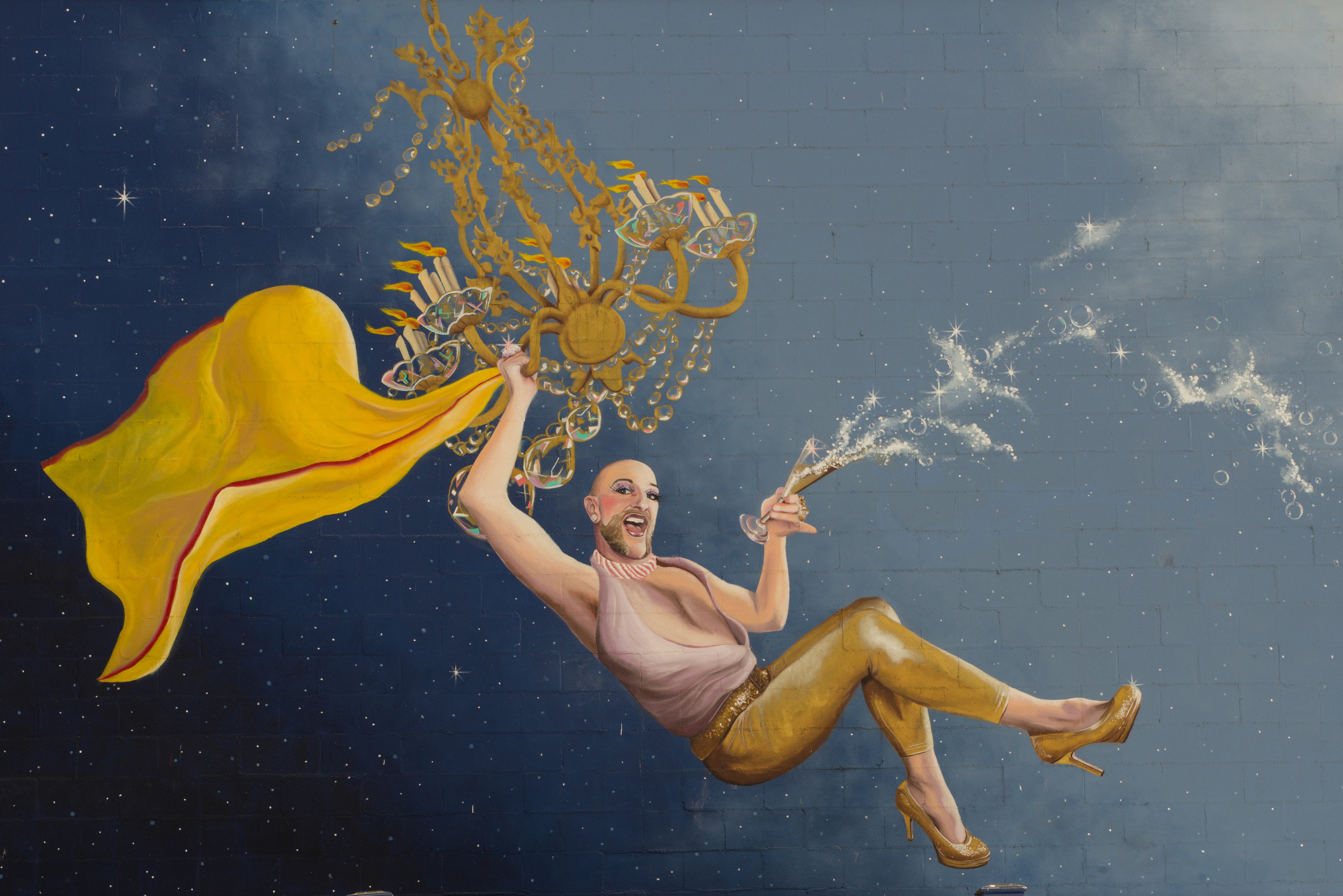 Mural of a man swinging from chandelier