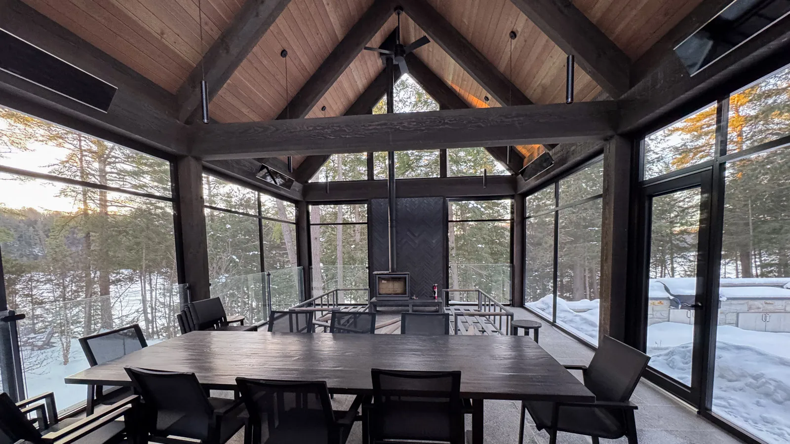 Screened in three-season room with dining area and fireplace.