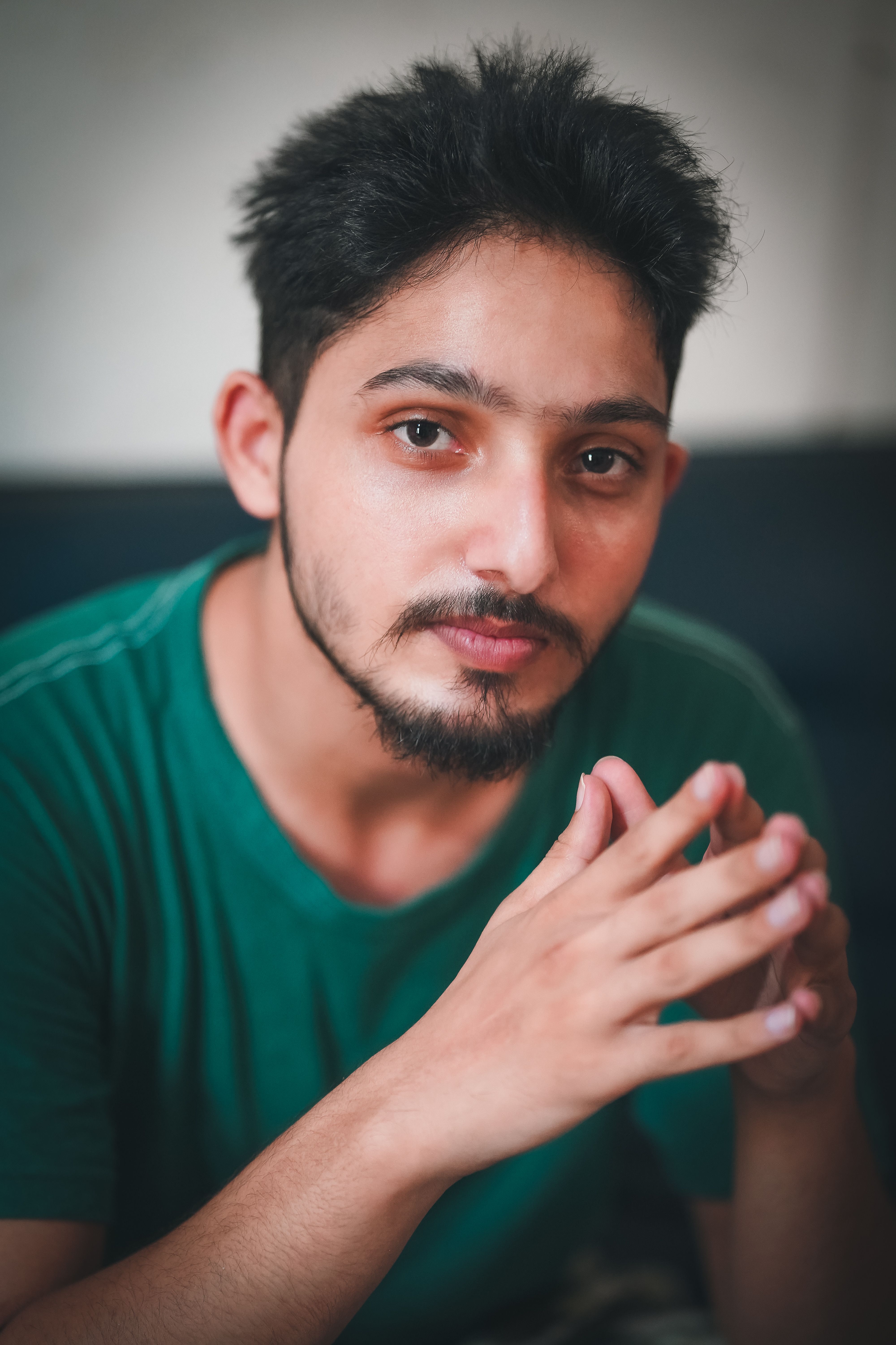 A person with a beard holding something in their hand.