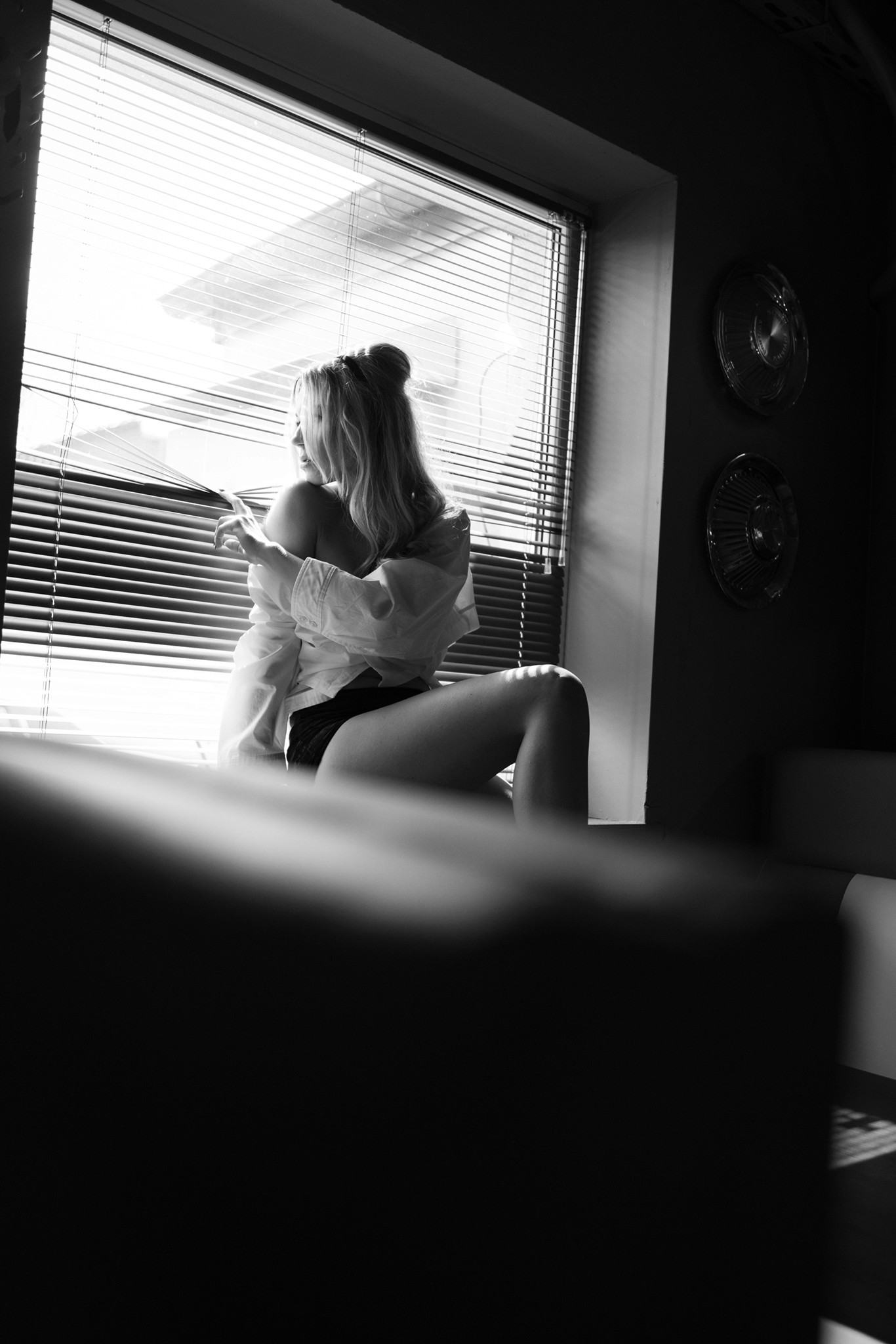 Agnieszka Czyzkowska fine art photography Warsaw woman by window shirt off shoulder black and white