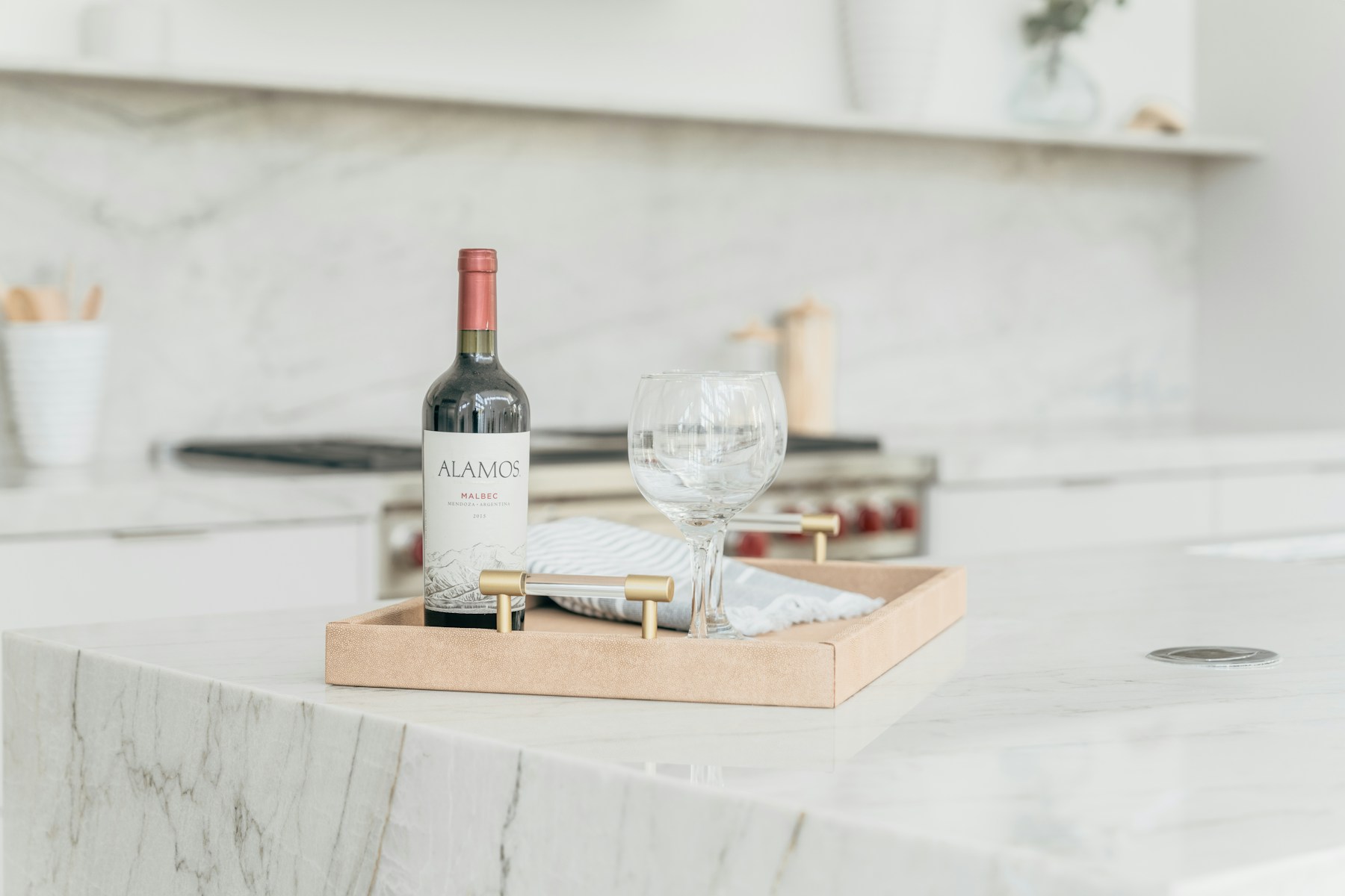 Marble worktop with a tray, a bottle and two glasses