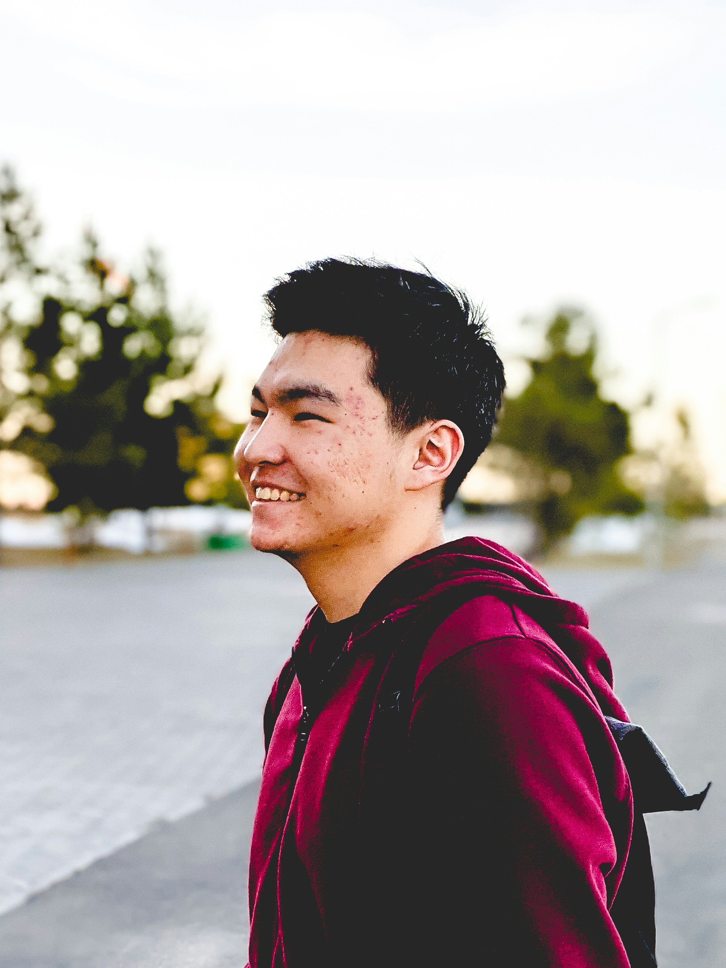 man in red and black jacket smiling