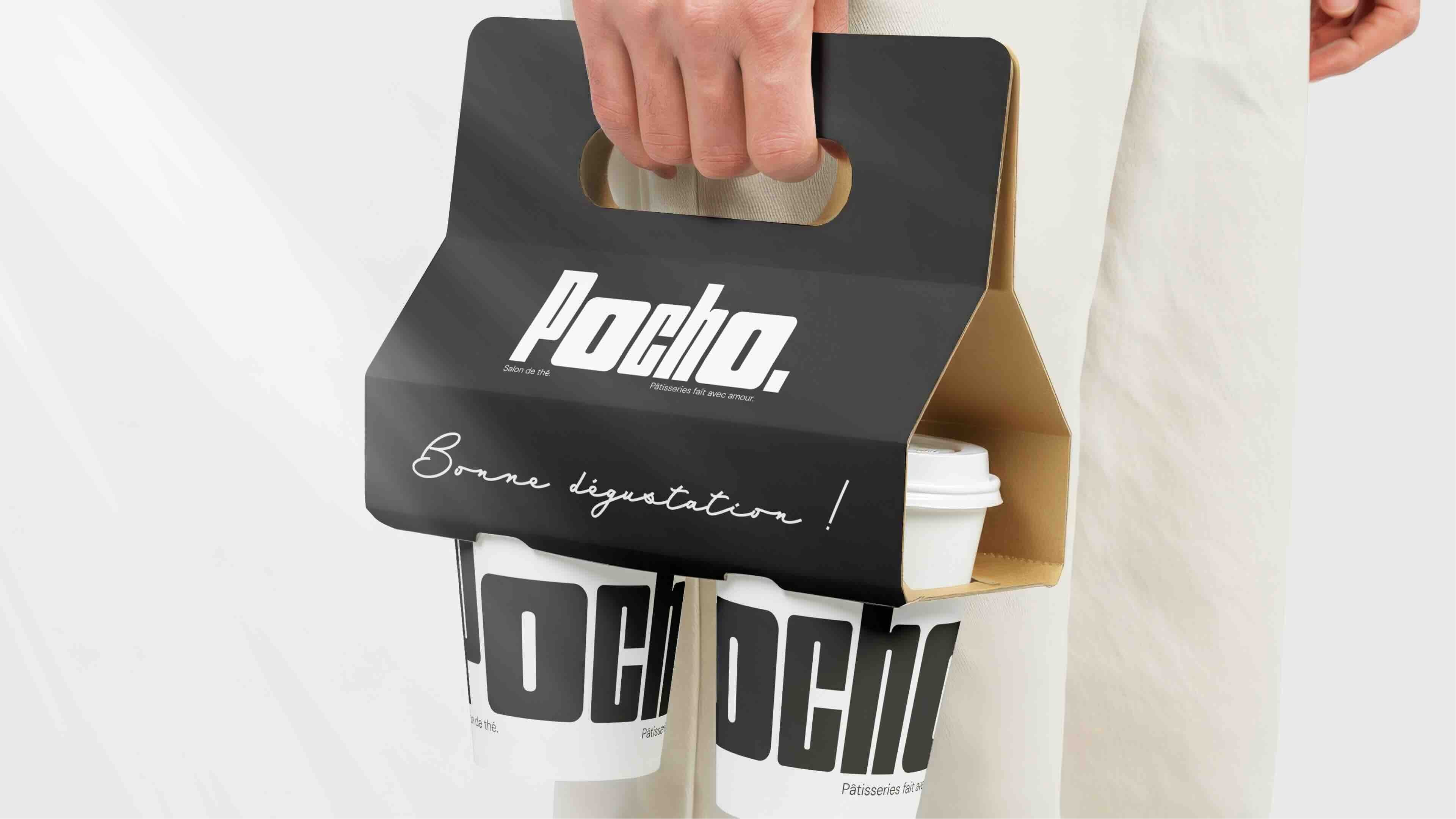 Close-up of a golf ball on green grass with a golf club behind it under a clear blue sky.