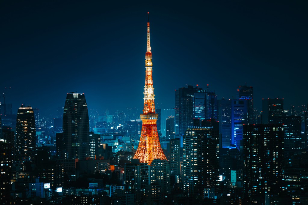 Tokyo Tower surrounded by buildings on a clear night