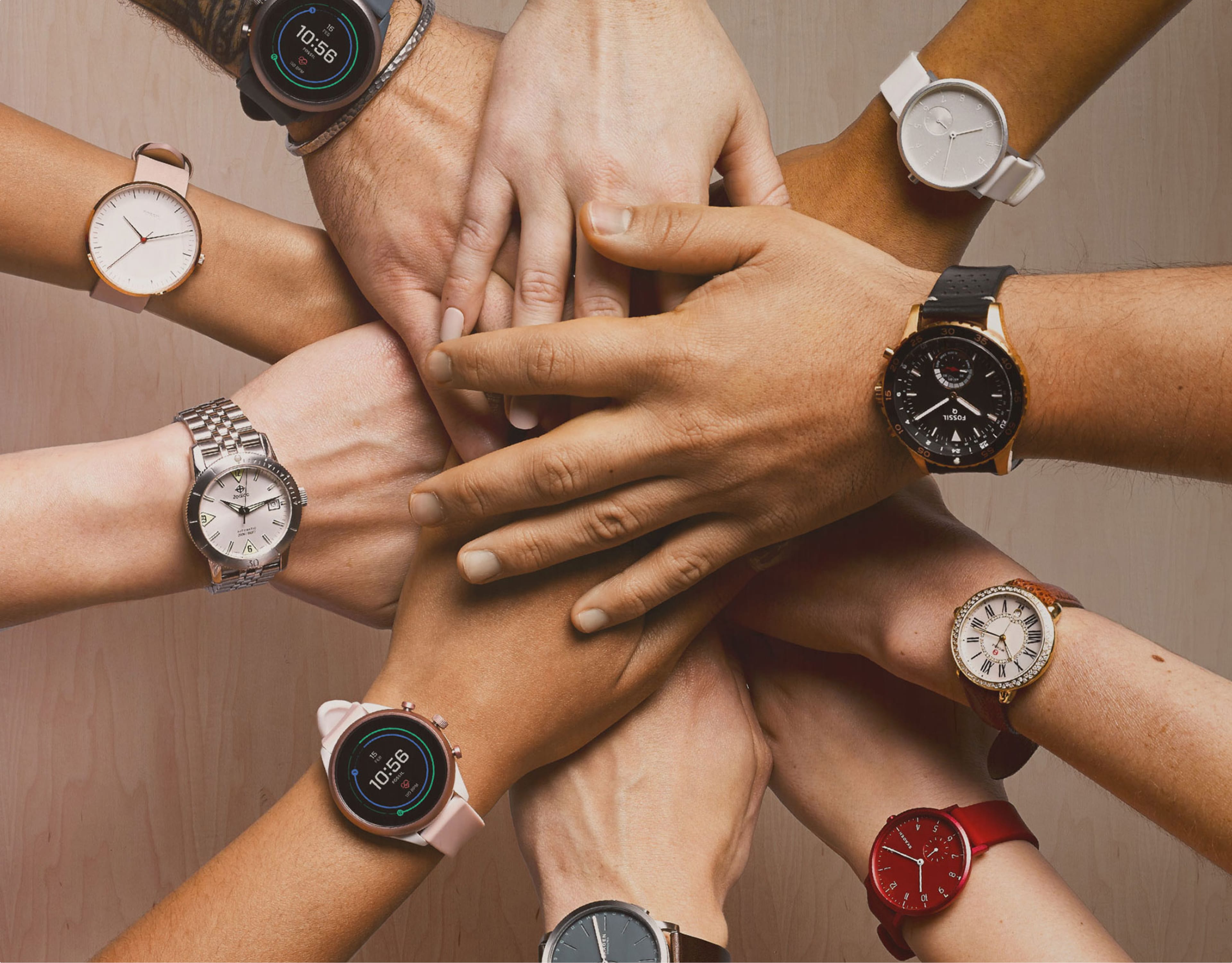 A group of diverse hands with Fossil watches