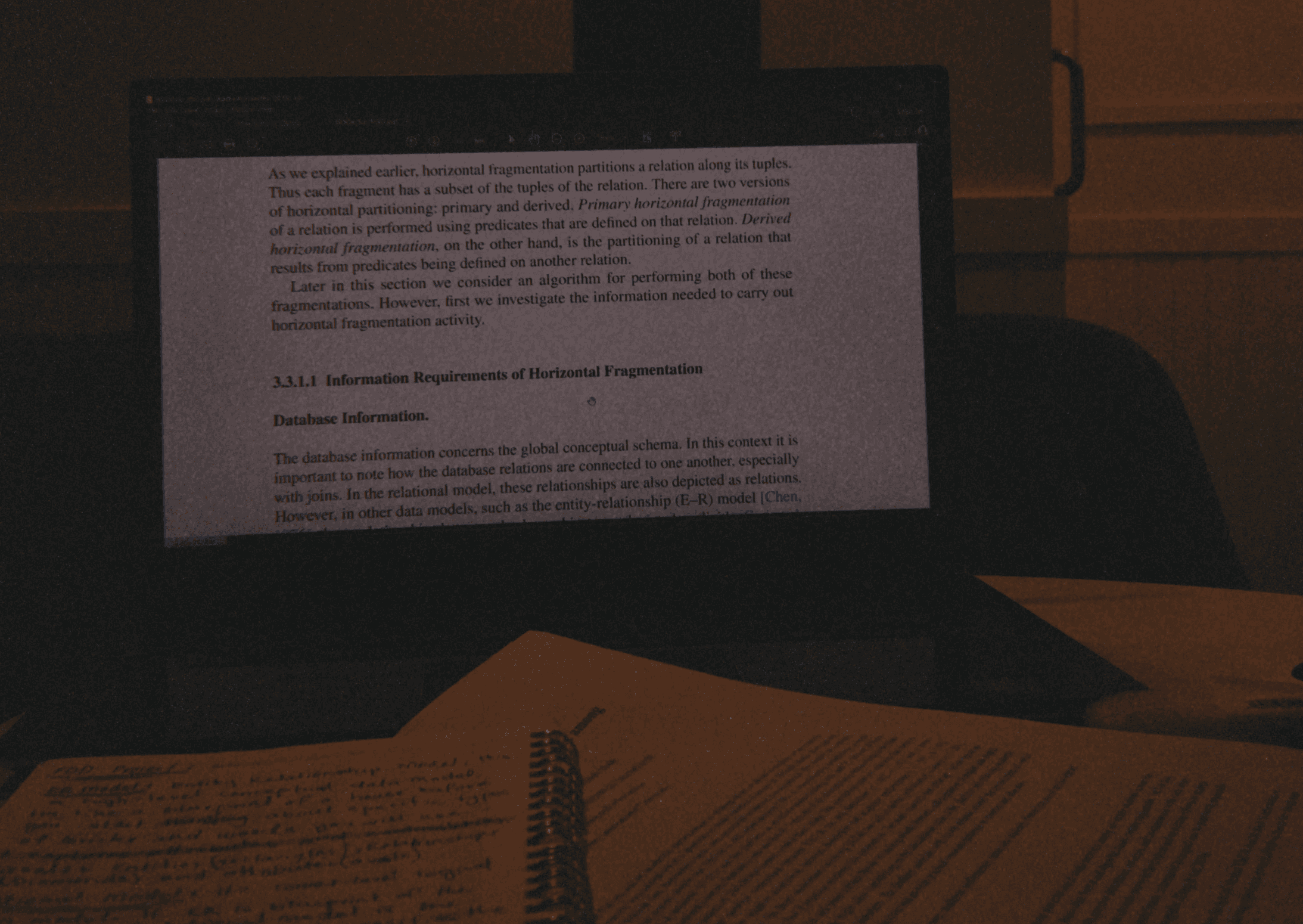 Hand holding an open book with text.