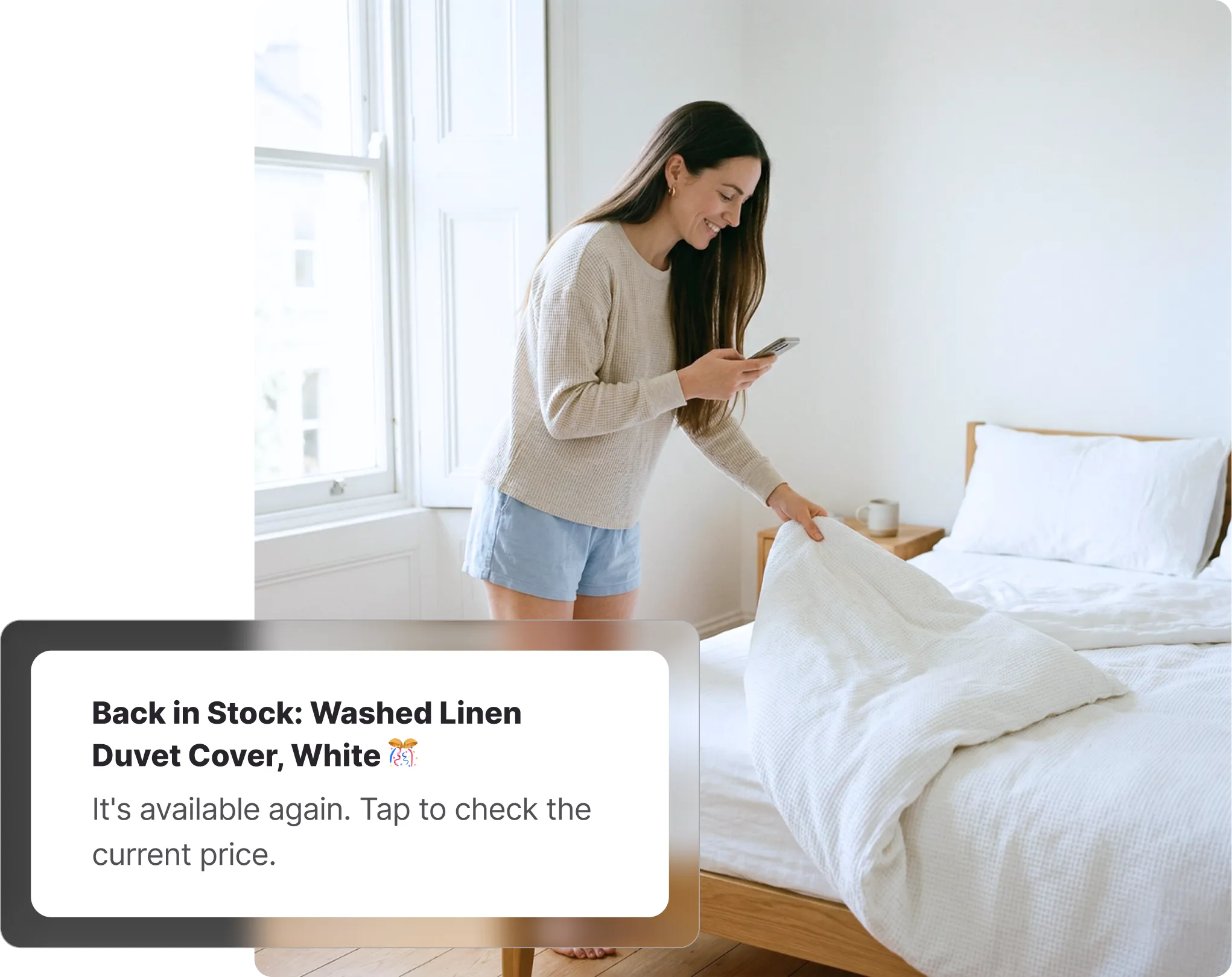 Woman checking her phone in a bedroom, with a Whisprice back-in-stock alert for a Zara Washed Linen Duvet Cover.