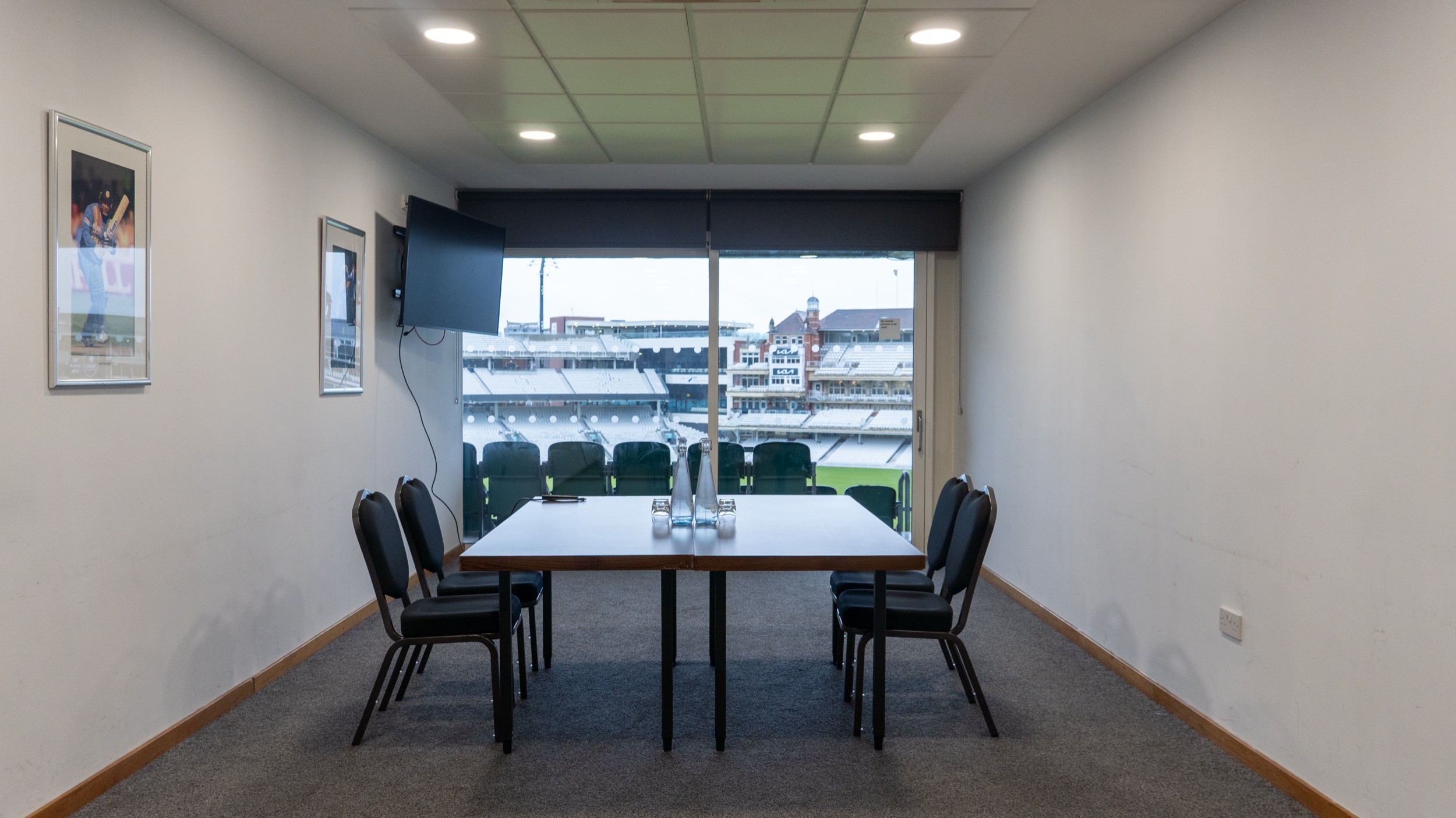 Two classic volkswagen beetles, one green, one cream.