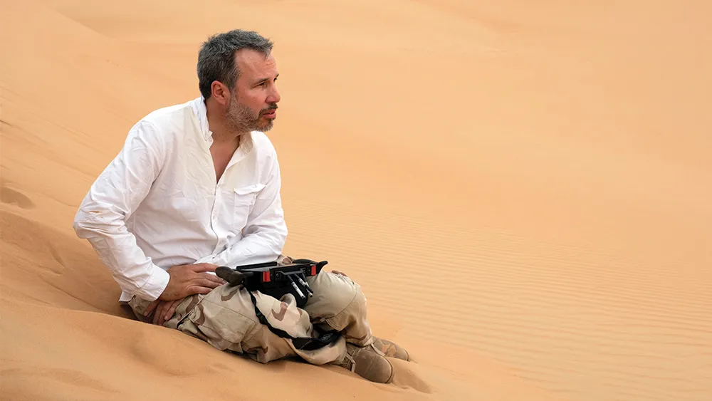 a vast desert stretches under a looming twilight sky, reflecting denis villeneuve's masterful use of landscapes to enhance the visual storytelling.