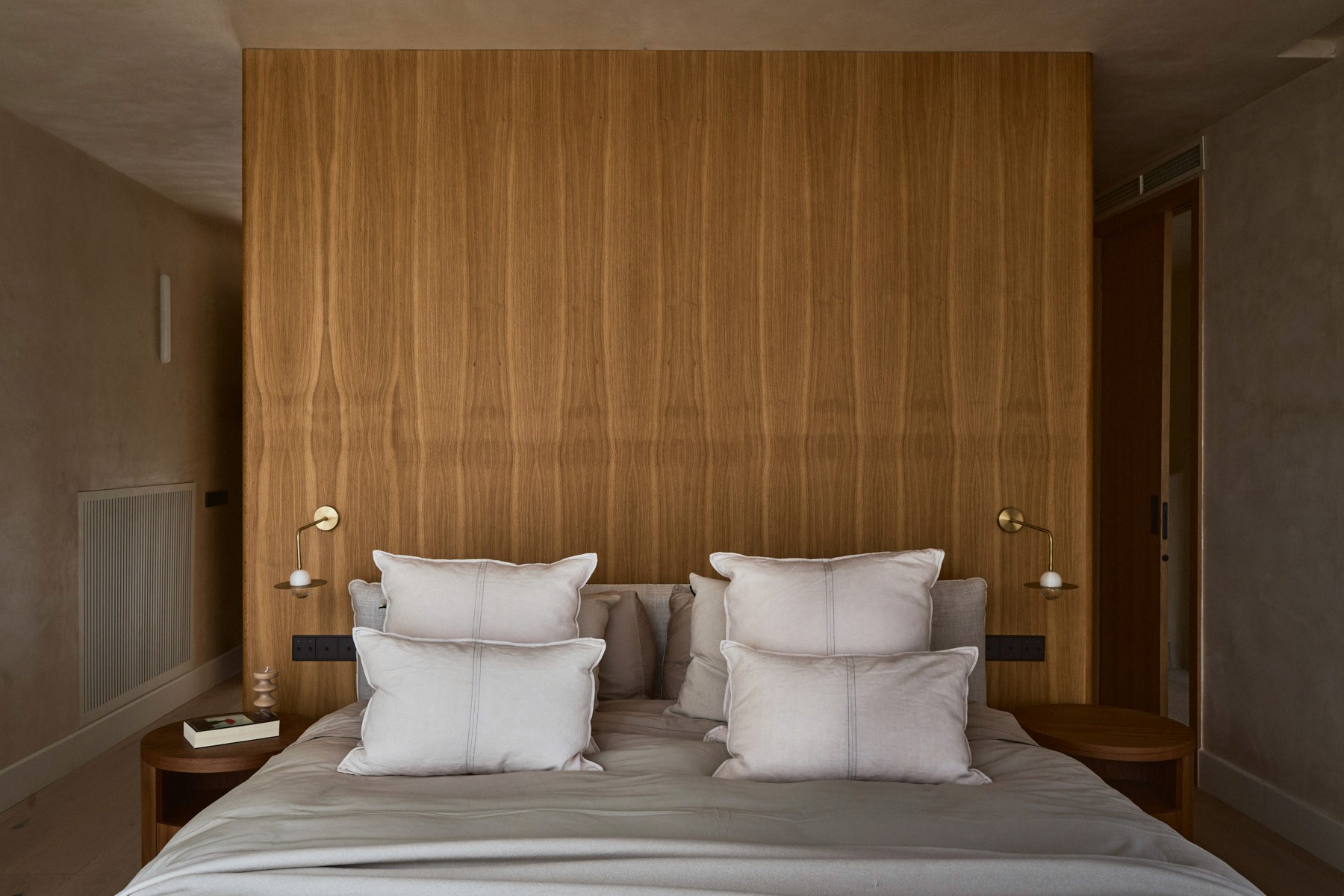 Master bedroom with bespoke oak headboard and integrated lighting.