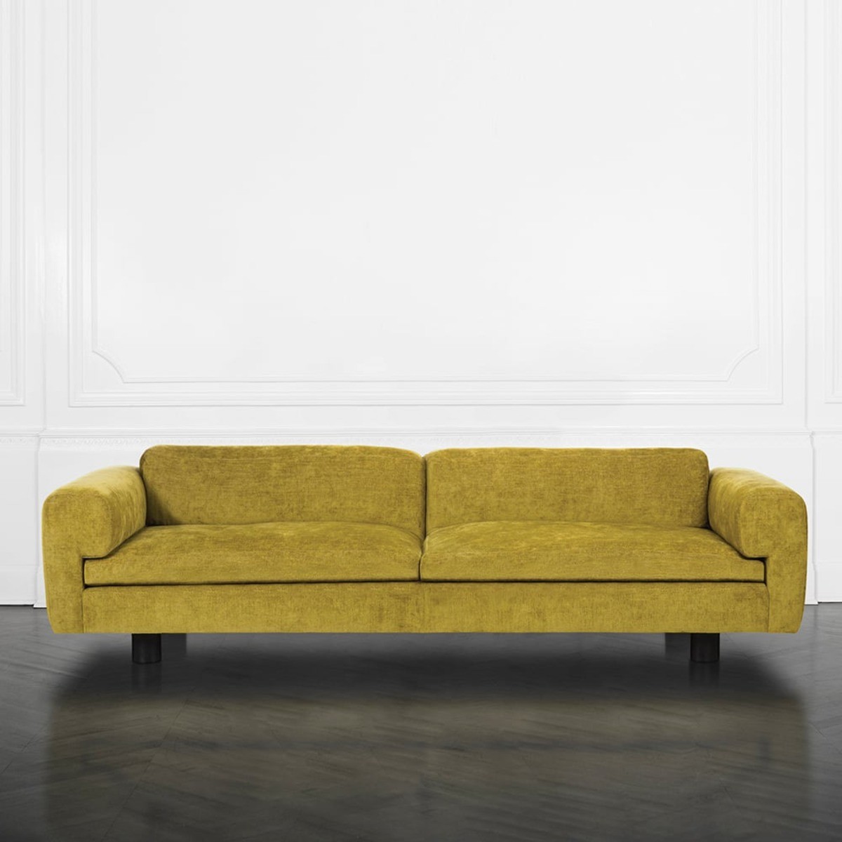 Yellow Durant sofa with rounded arms and low-profile design against a white background