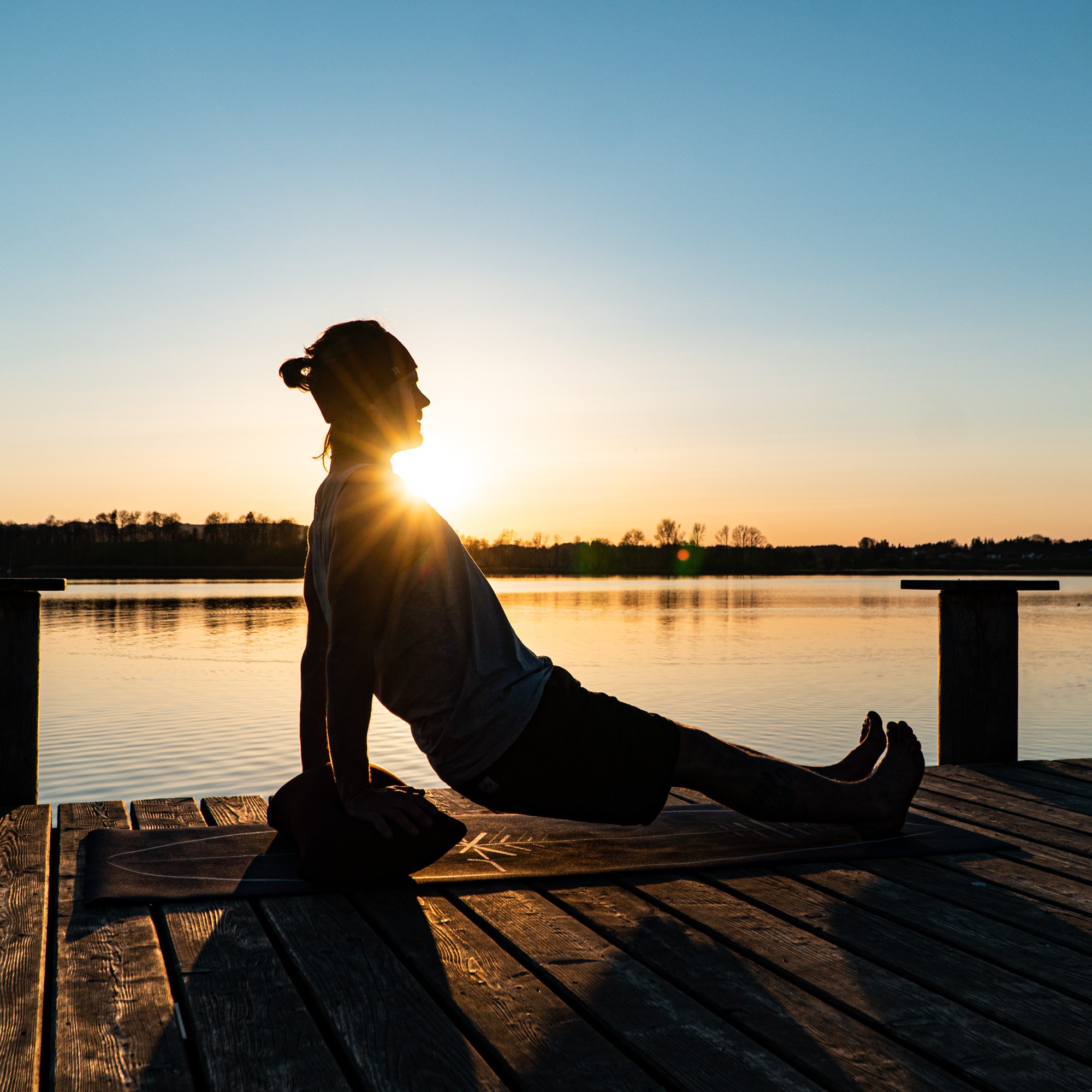 A quiet session on the jetty at sunrise, propped on the BOLSTair, Tobi Deckert's own inflatable training cushion — mental rehearsal is the part of the preparation that costs nothing and delivers most