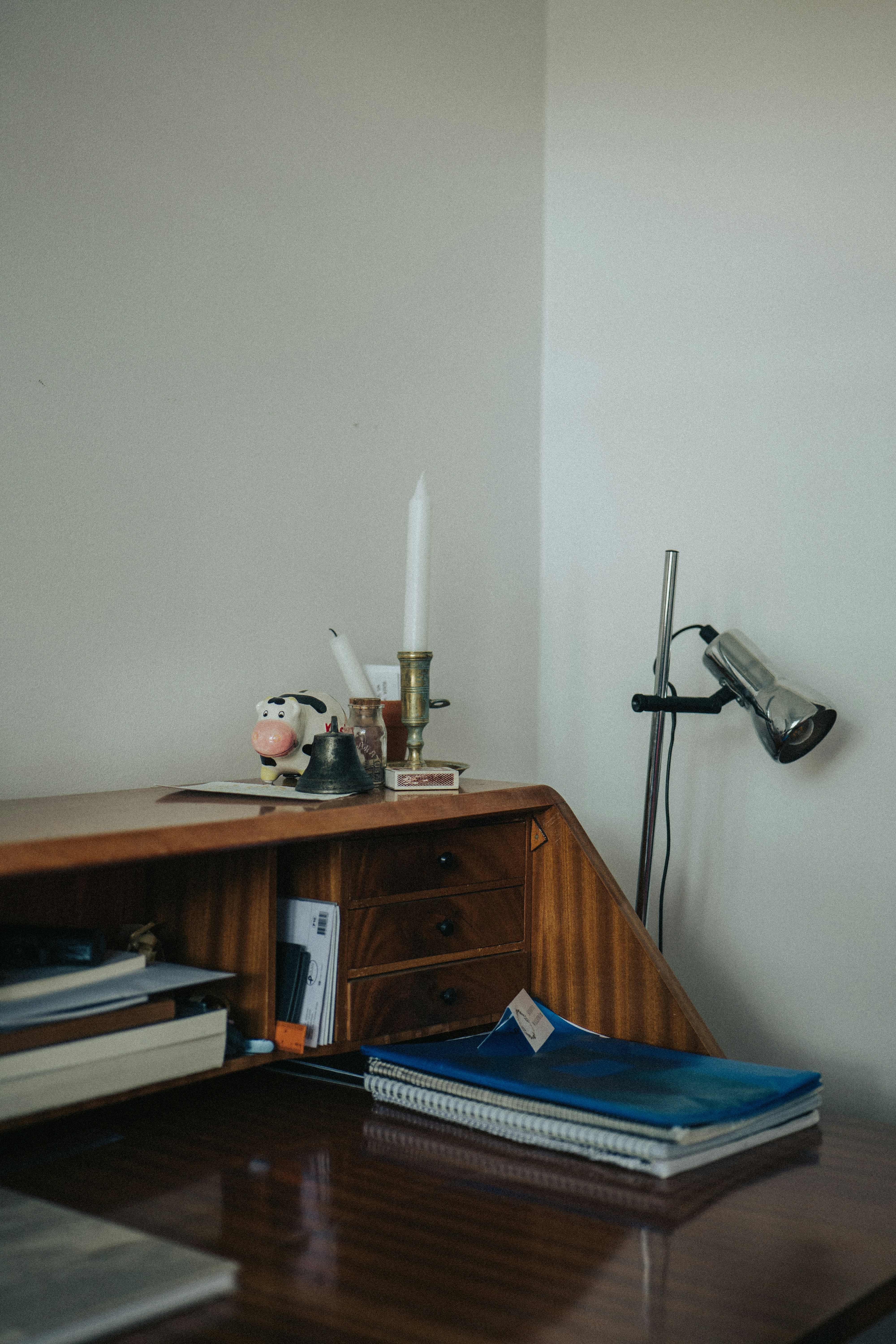Wood desk and chair in a quiet office corner.