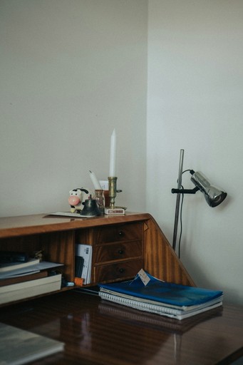 Wood desk and chair in a quiet office corner.