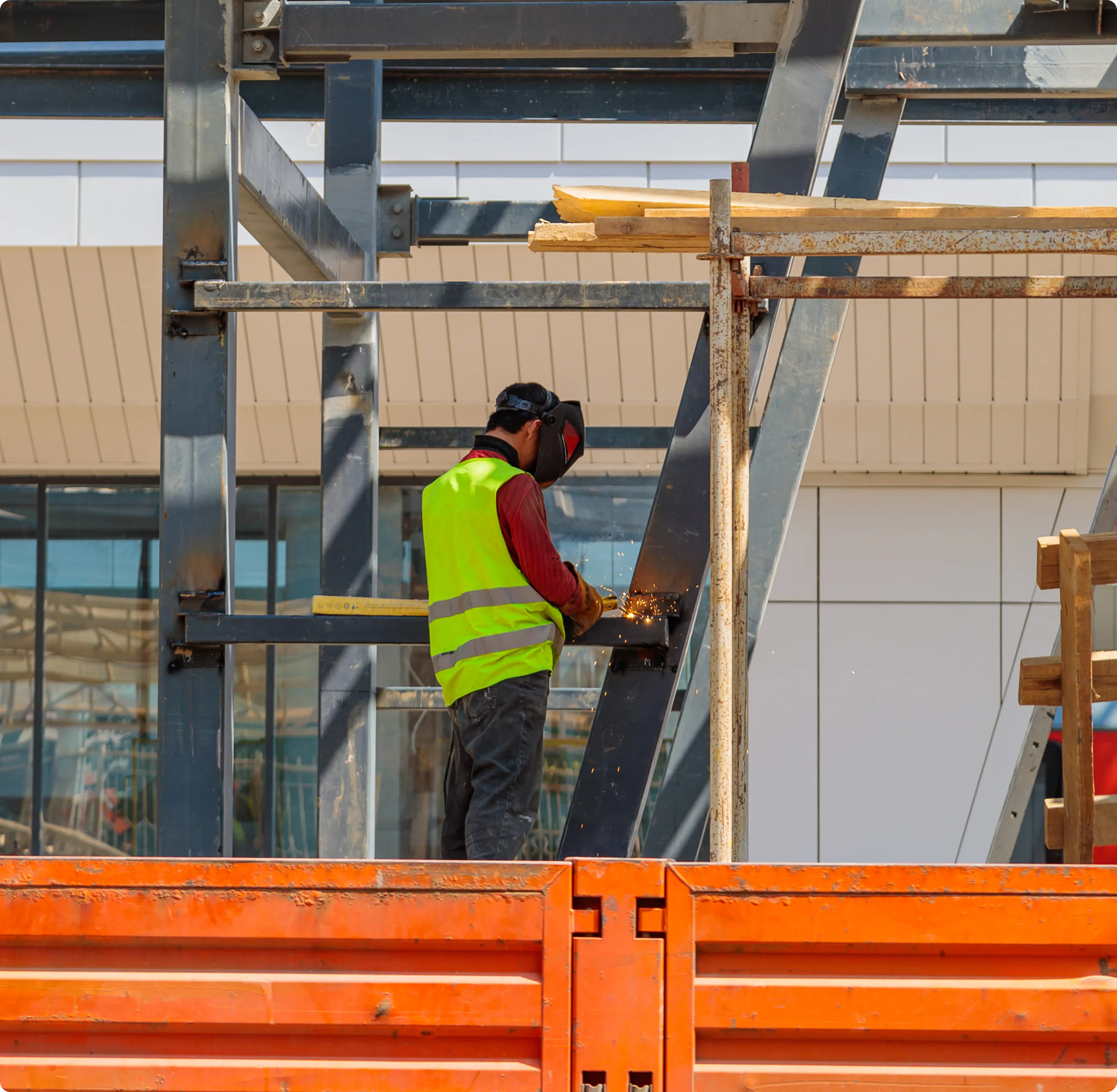 Professional electrician in a white hardhat inspecting complex electrical wiring systems.